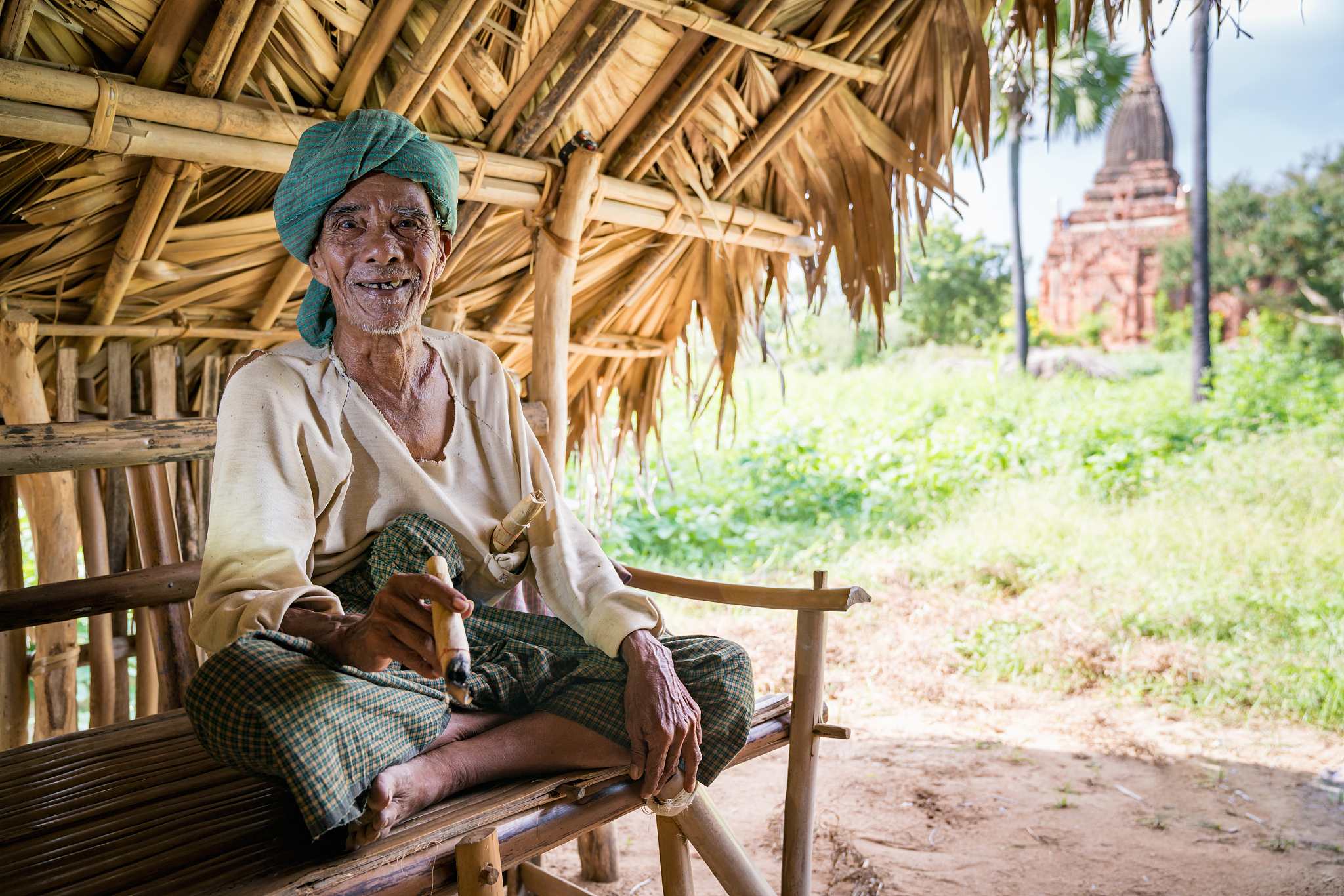 burmese old man hut smoking cigar bagan myanmar