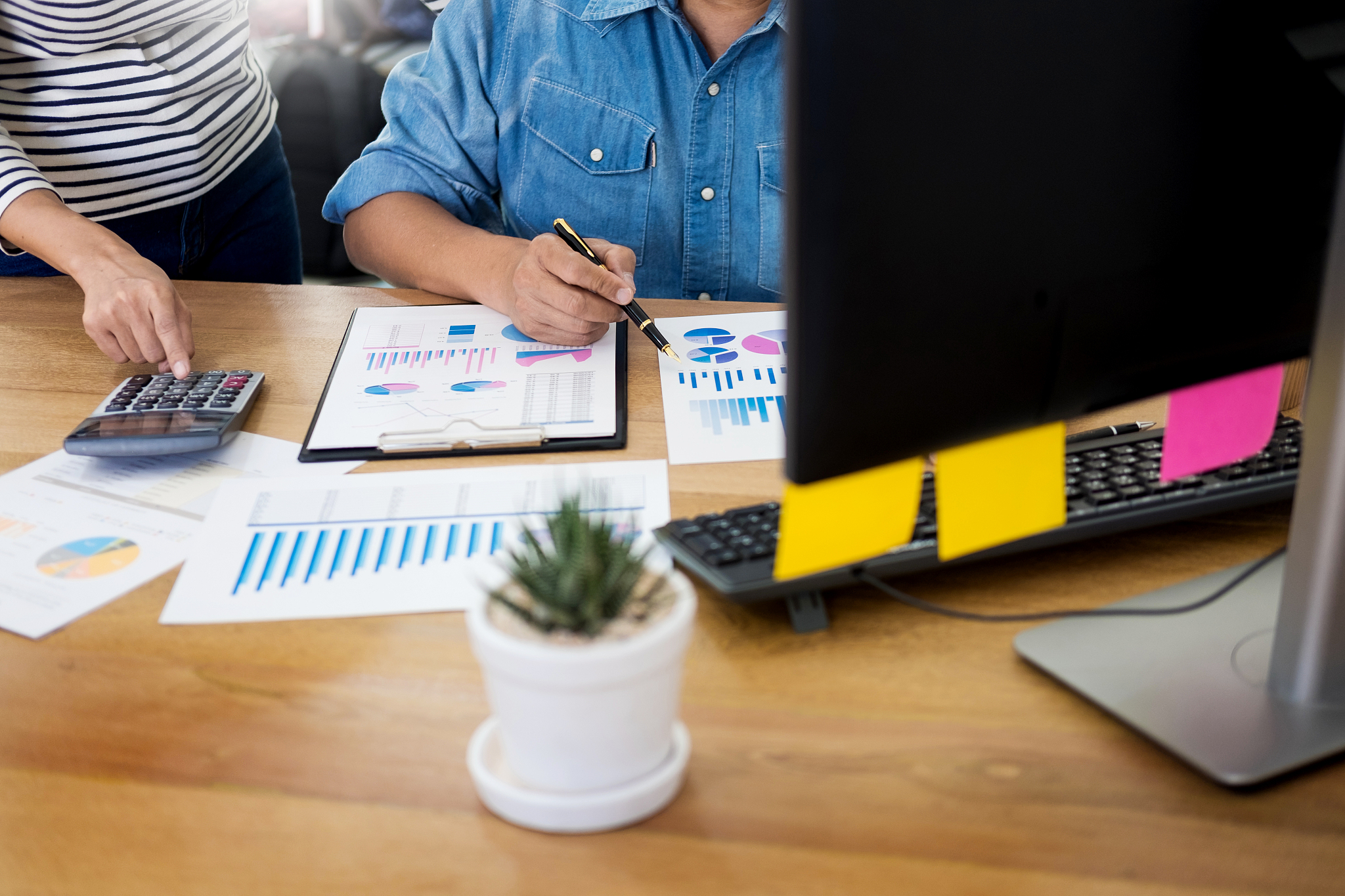 midsection of man working with colleague at office