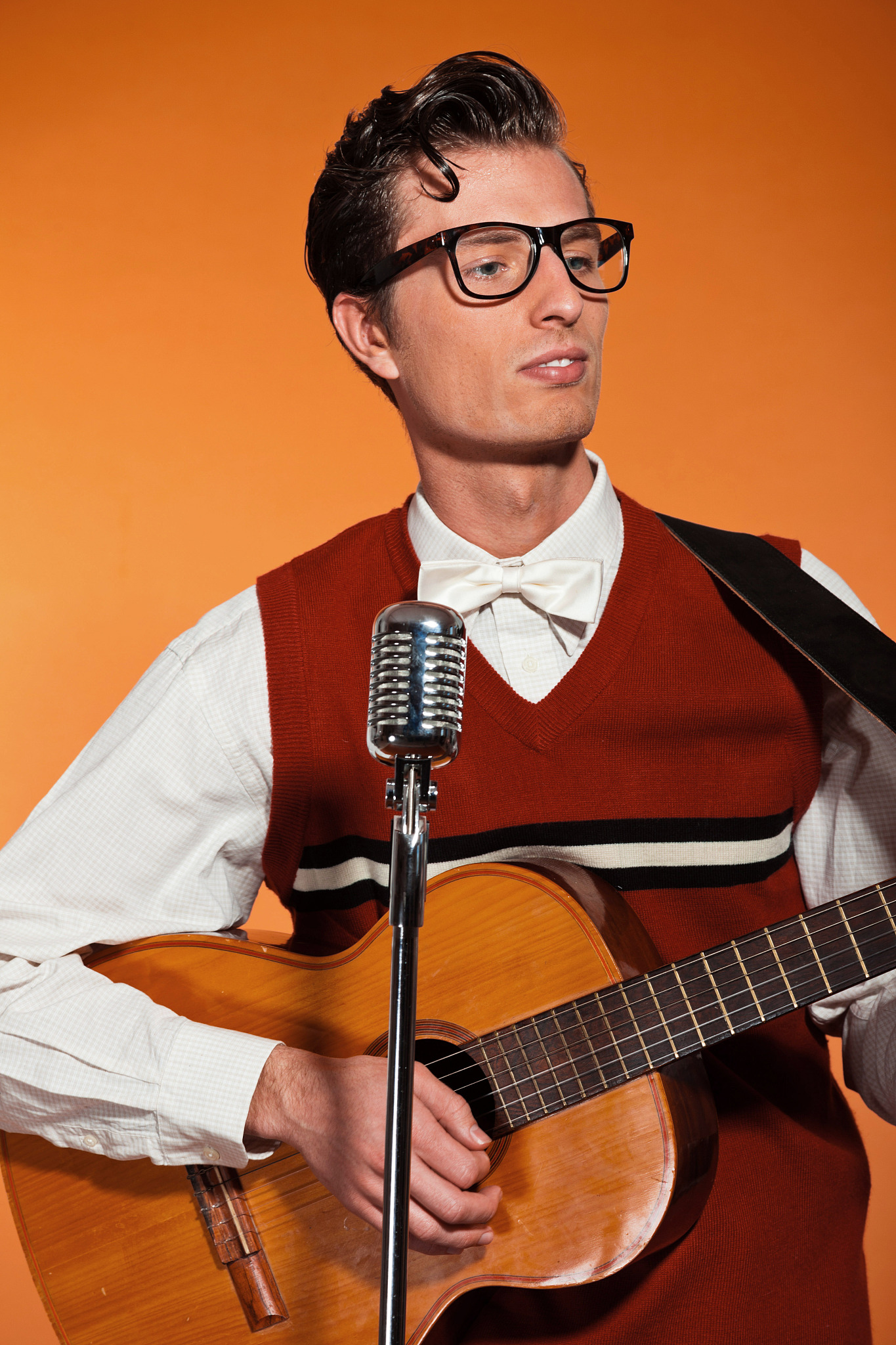 retro fifties musician with glasses playing acoustic guitar.
