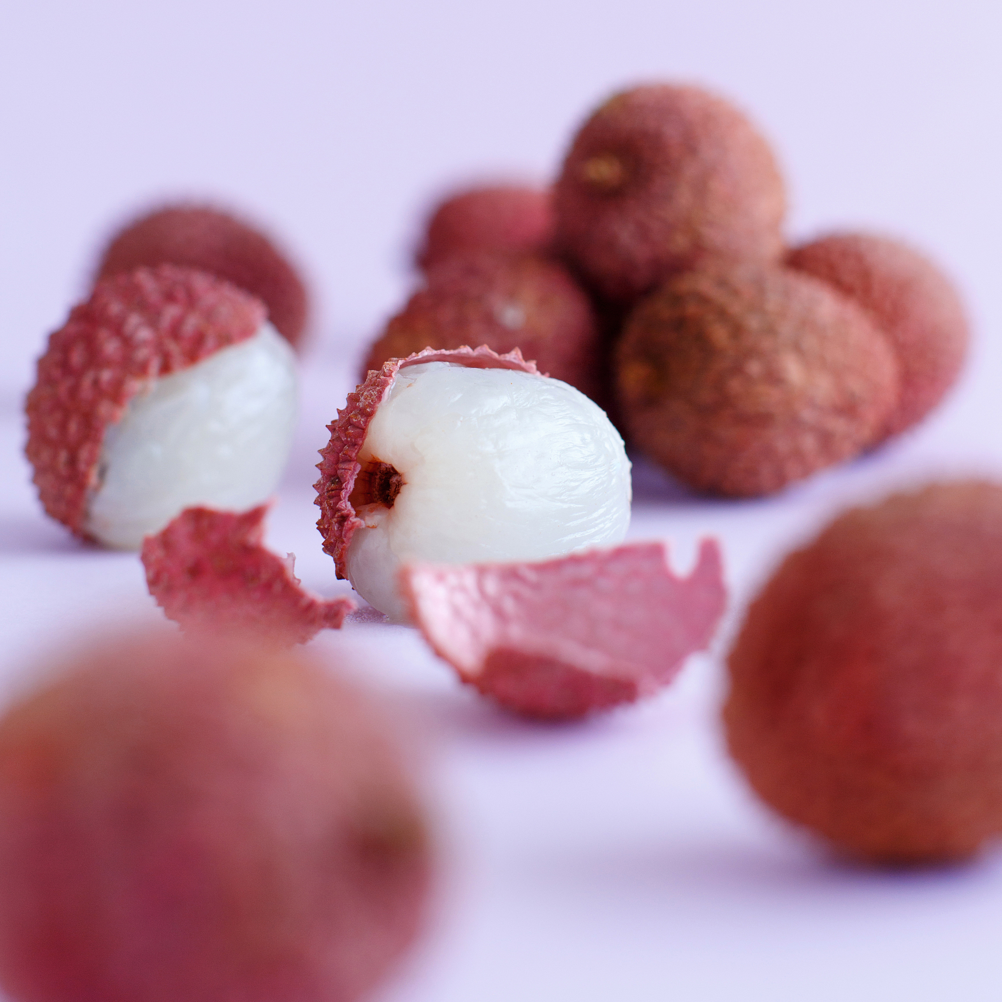 fresh litchi fruits on a lavender backgrpund