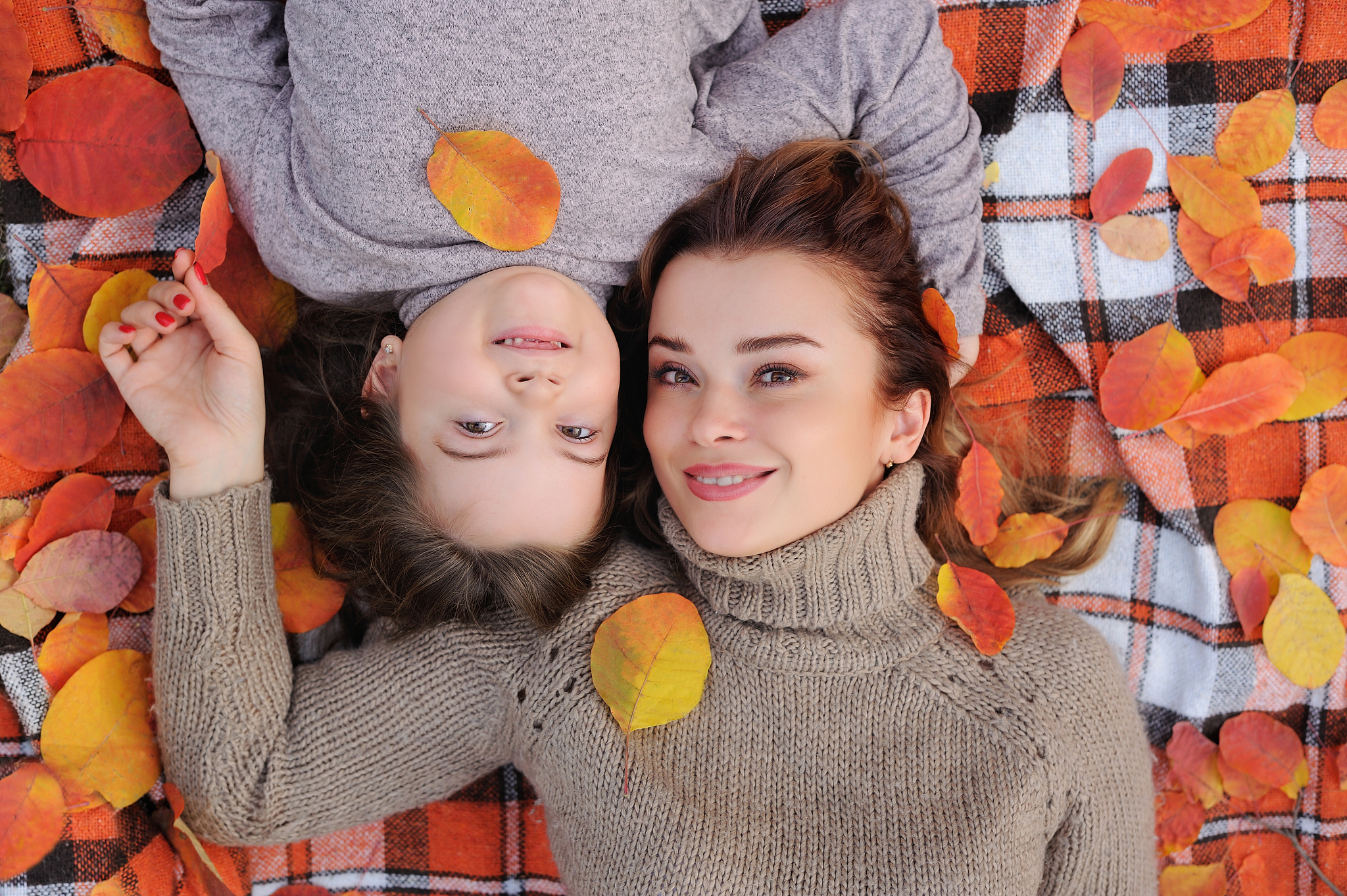 top view of mother and daughter laying on the plaid