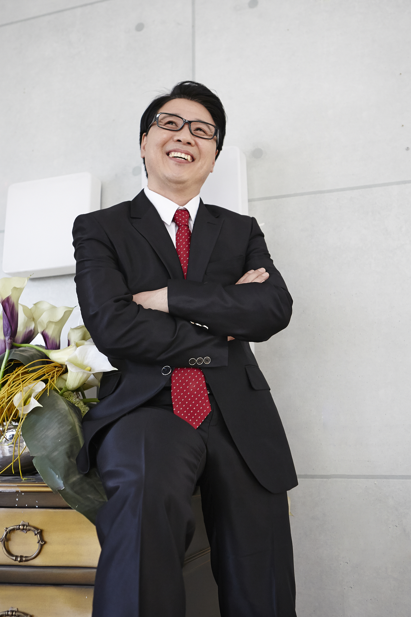 photography of businessman smiling arms crossed