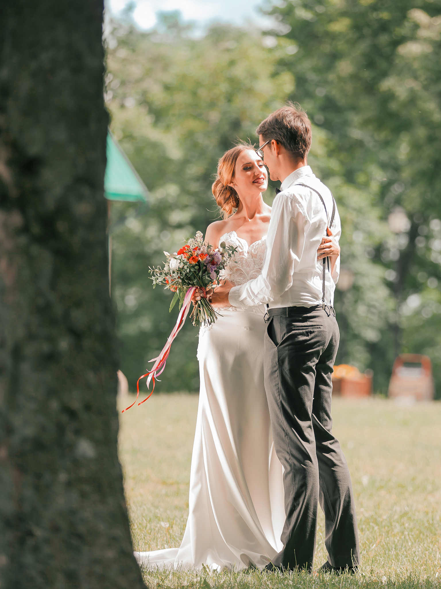 beautiful loving couple standing on the lawn in the city park