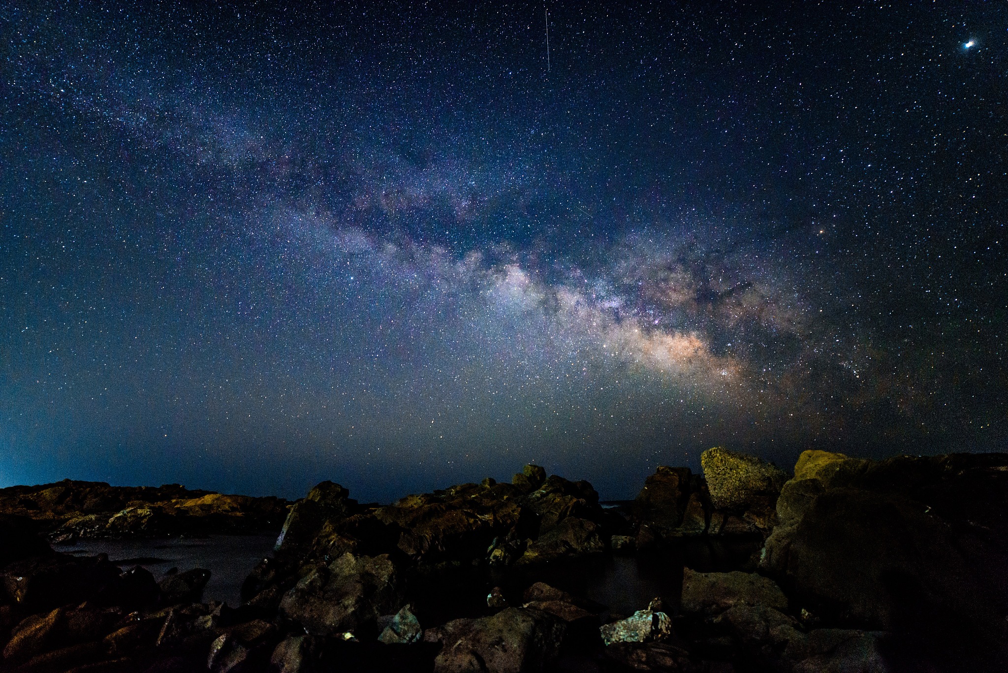 scenic view of rock formation against sky at night