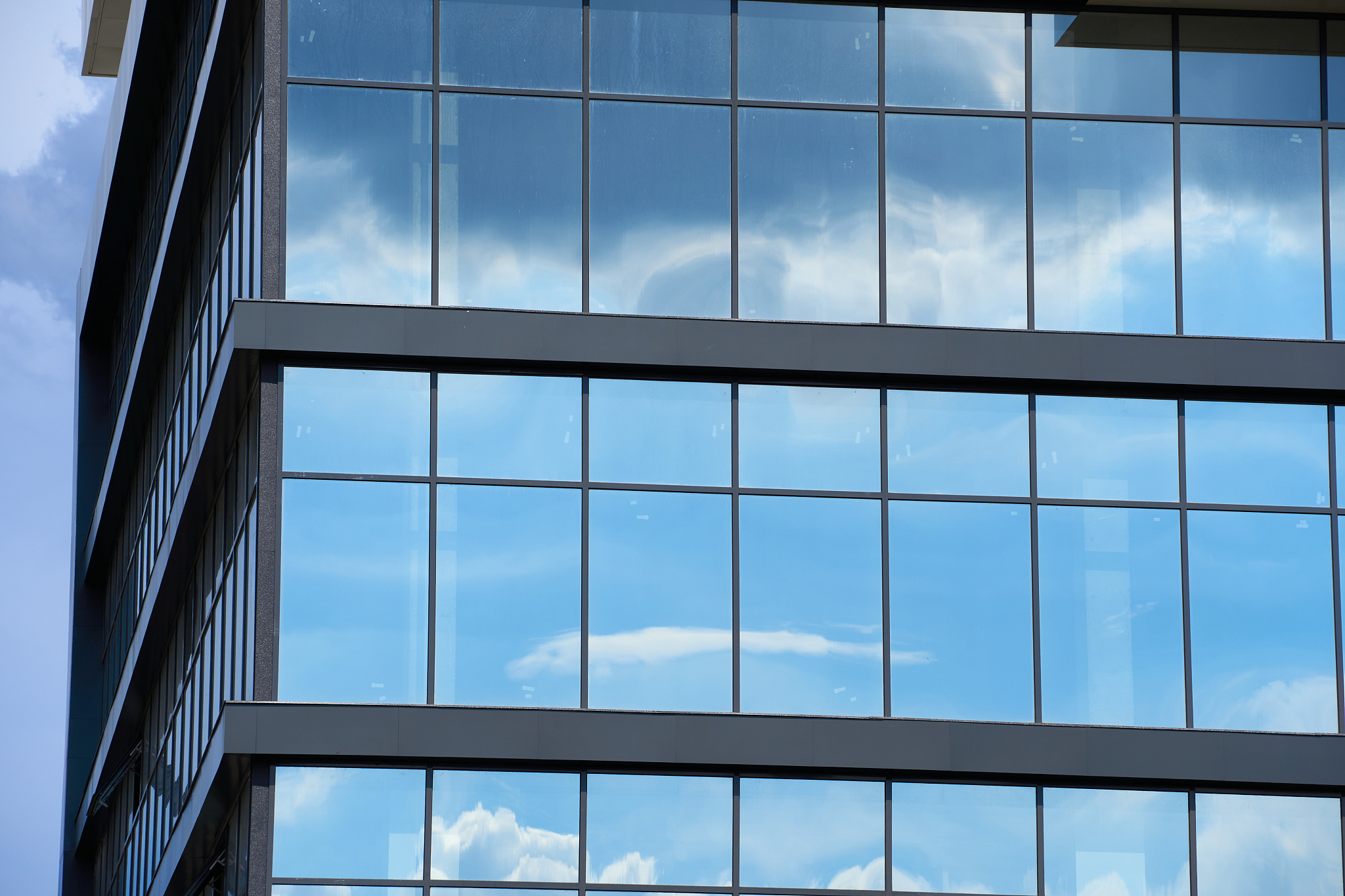 facade of a modern building on a bright sunny day, blue sky and 