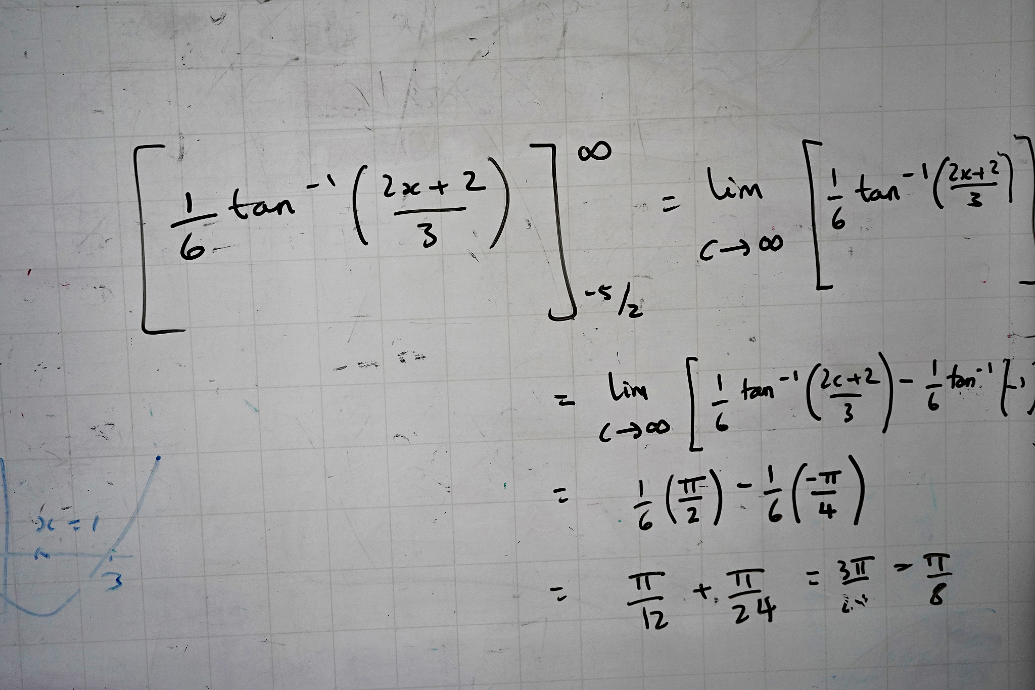 maths and equations on a whiteboard in a classroom