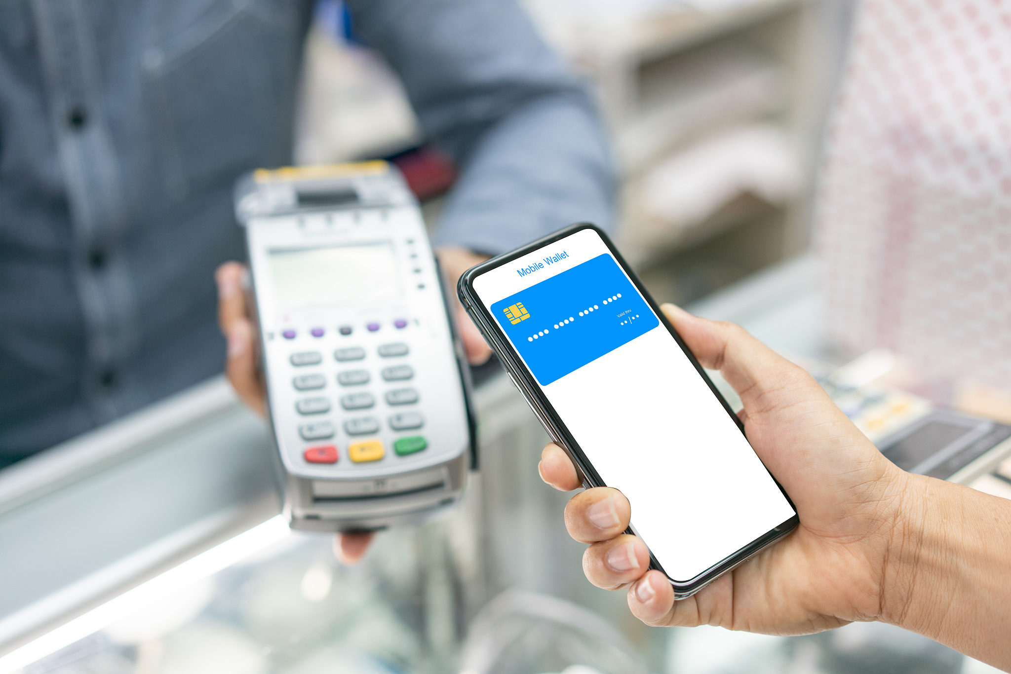 cropped image of man using nfc technology to pay bill at cinema