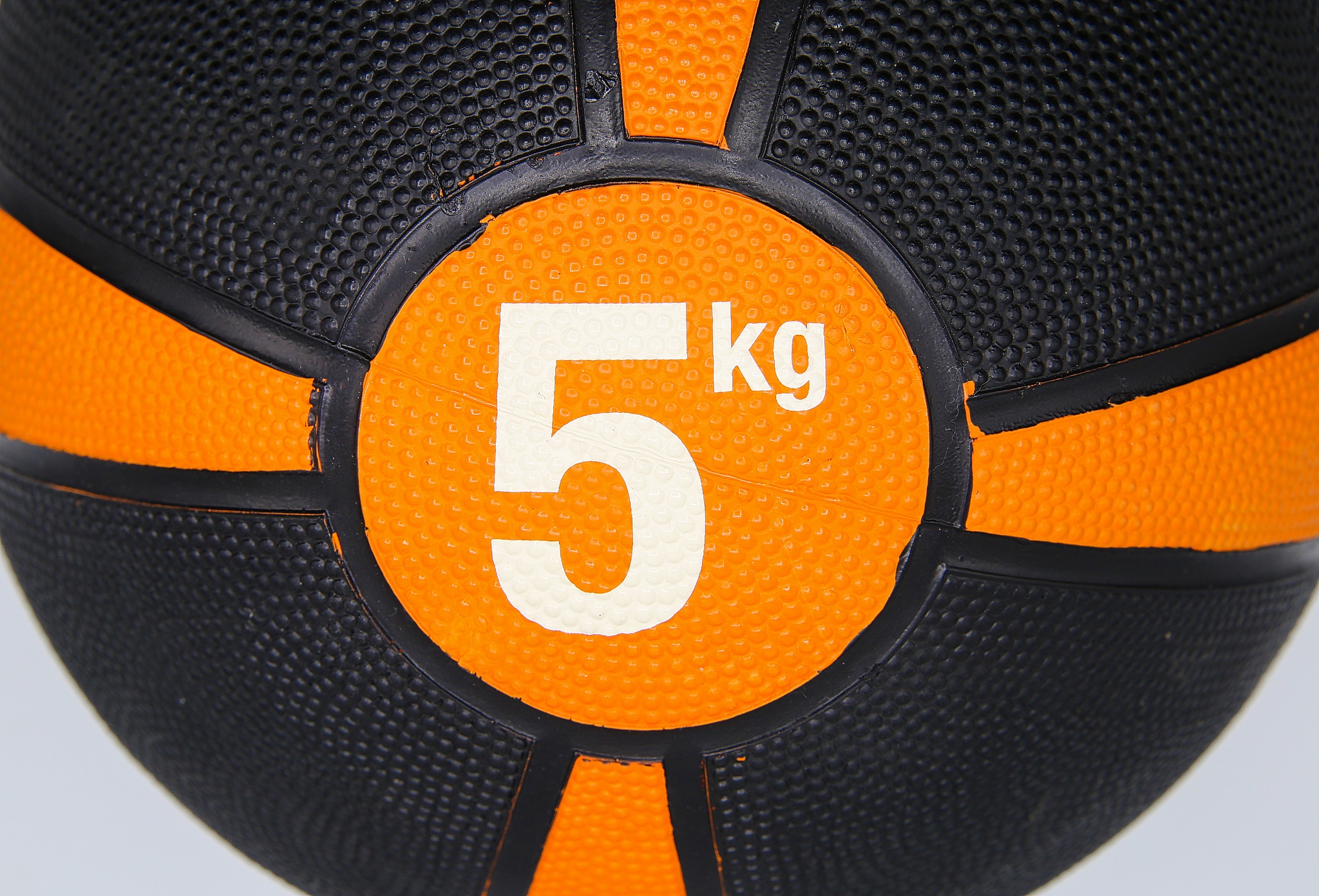 close up of isolated black and orange color medicine ball with w