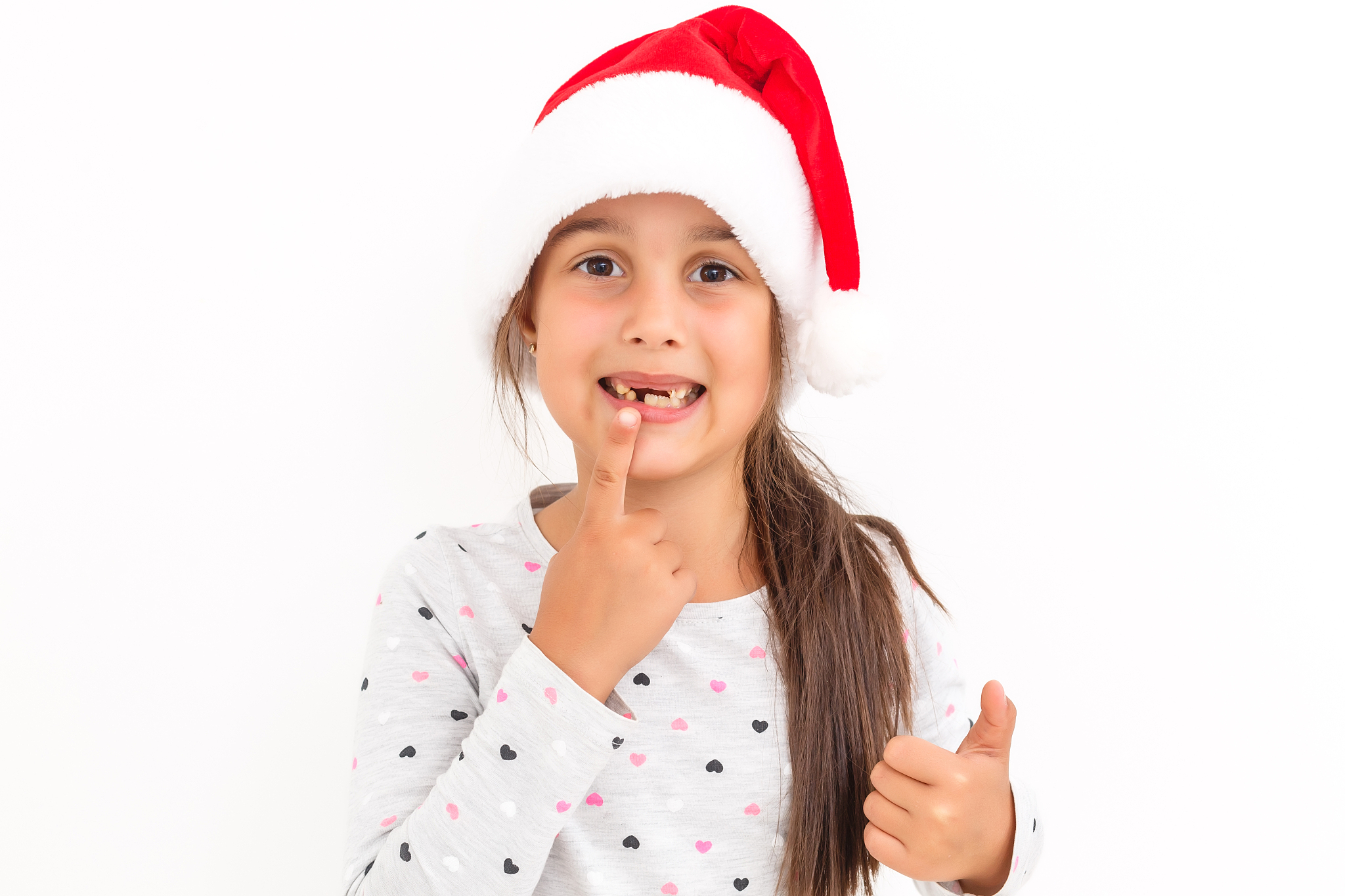 cute little girl in the santa claus hat on a white background