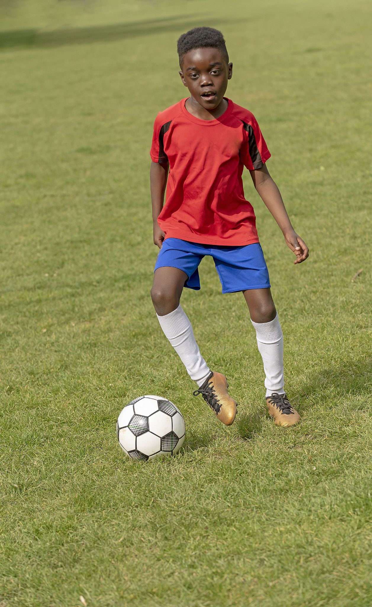 hampshire, england, uk, a nine year old footballer dribbles the 