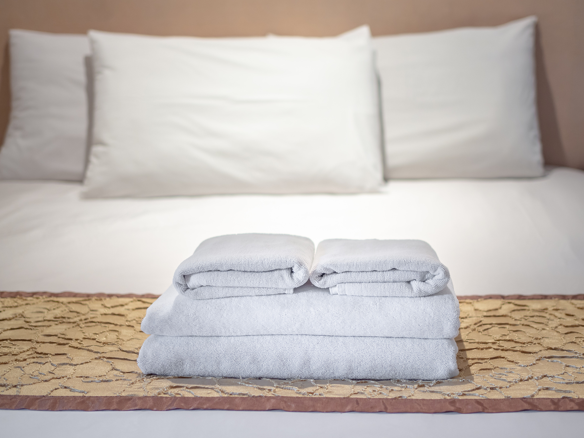 folded towels on bed at home