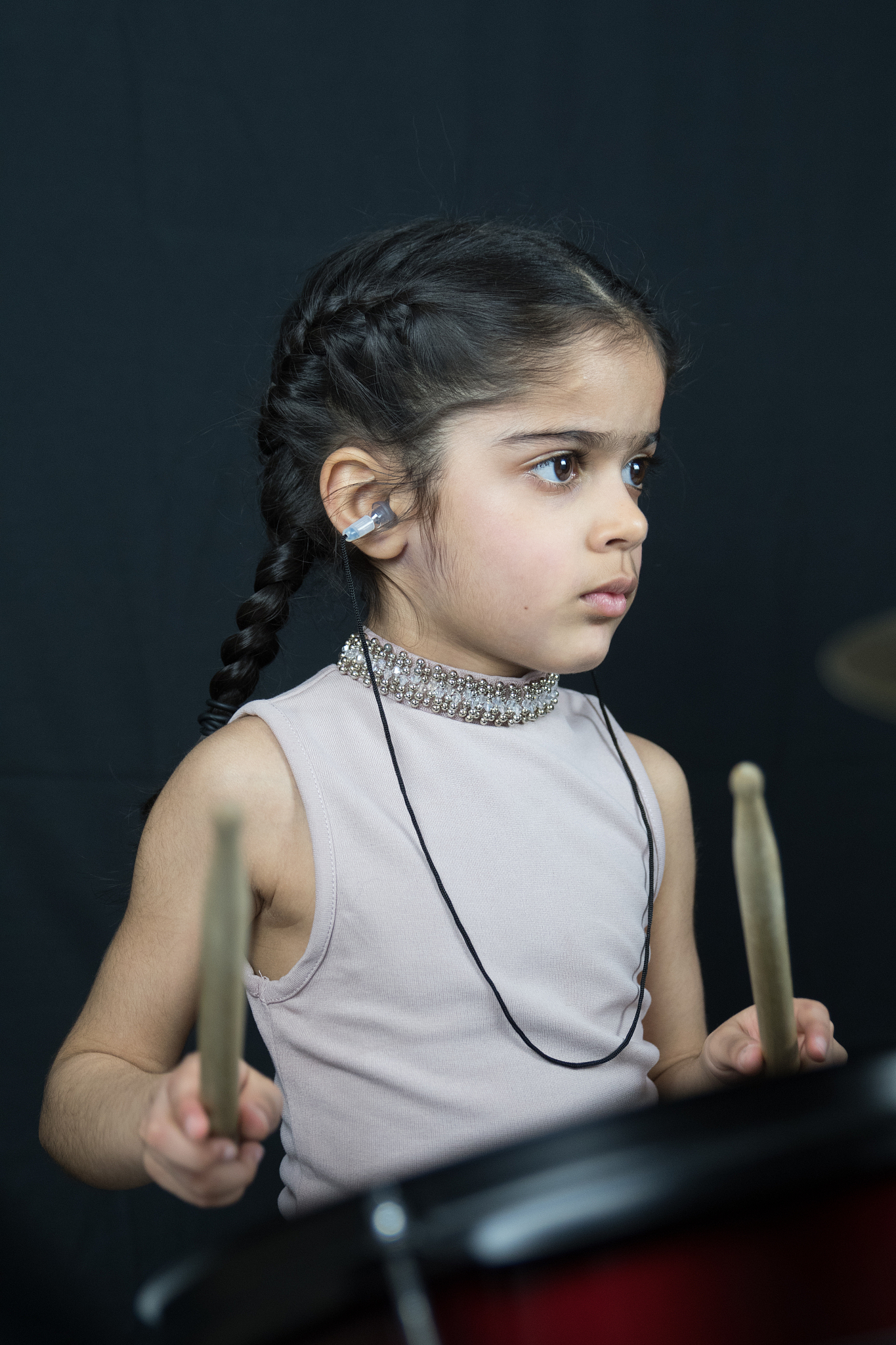 5 year old girl practices the drums