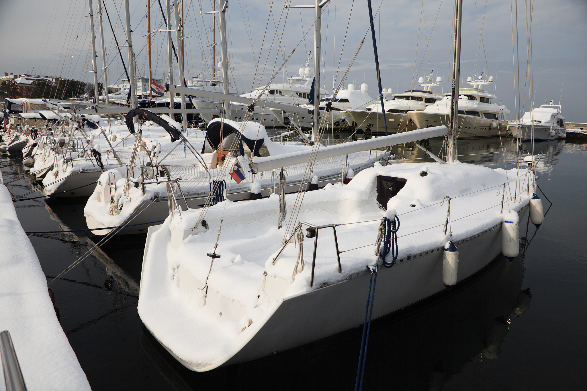 yachts and boats under the snow