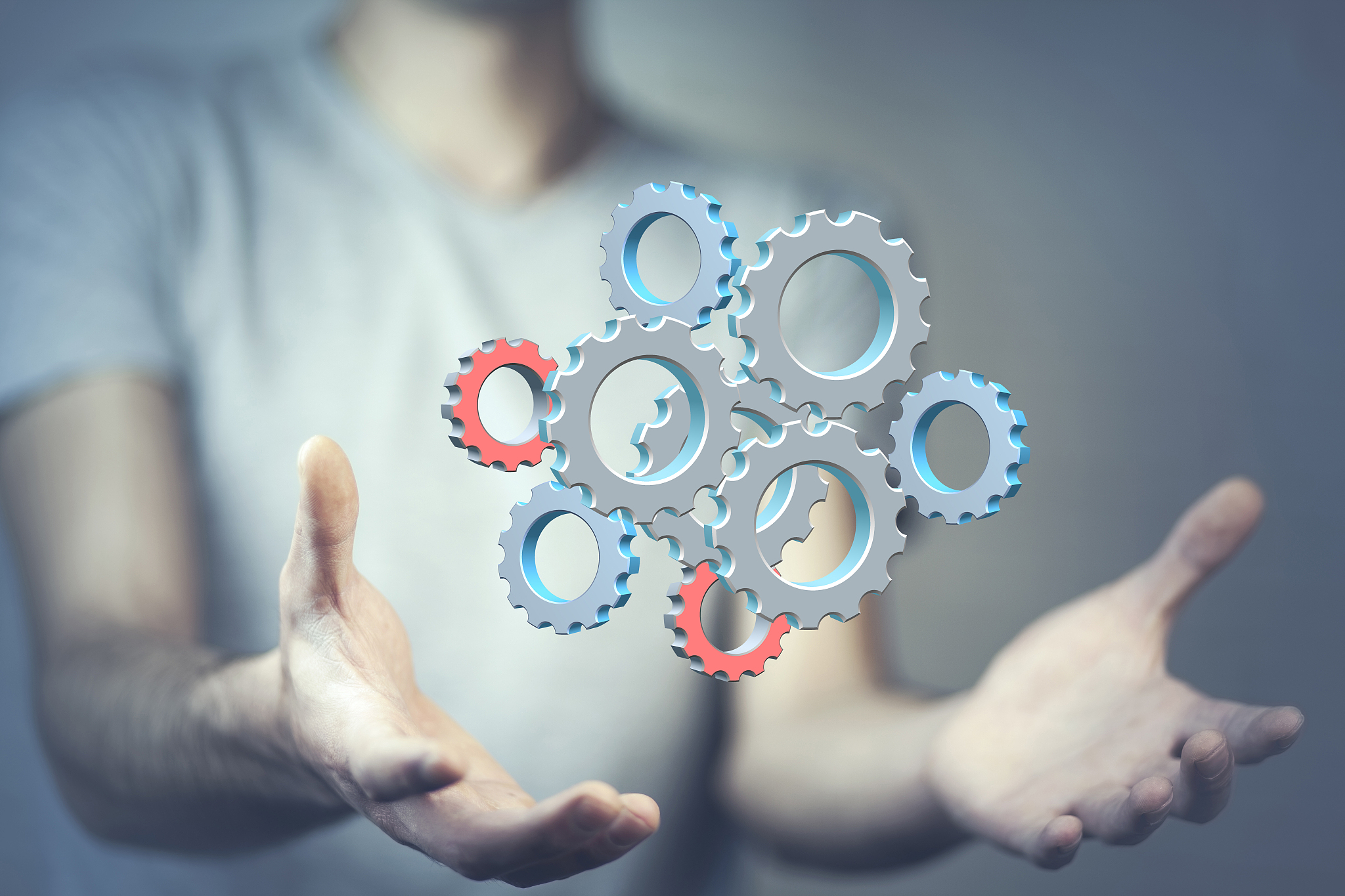 close up of businessman holding gears in palms