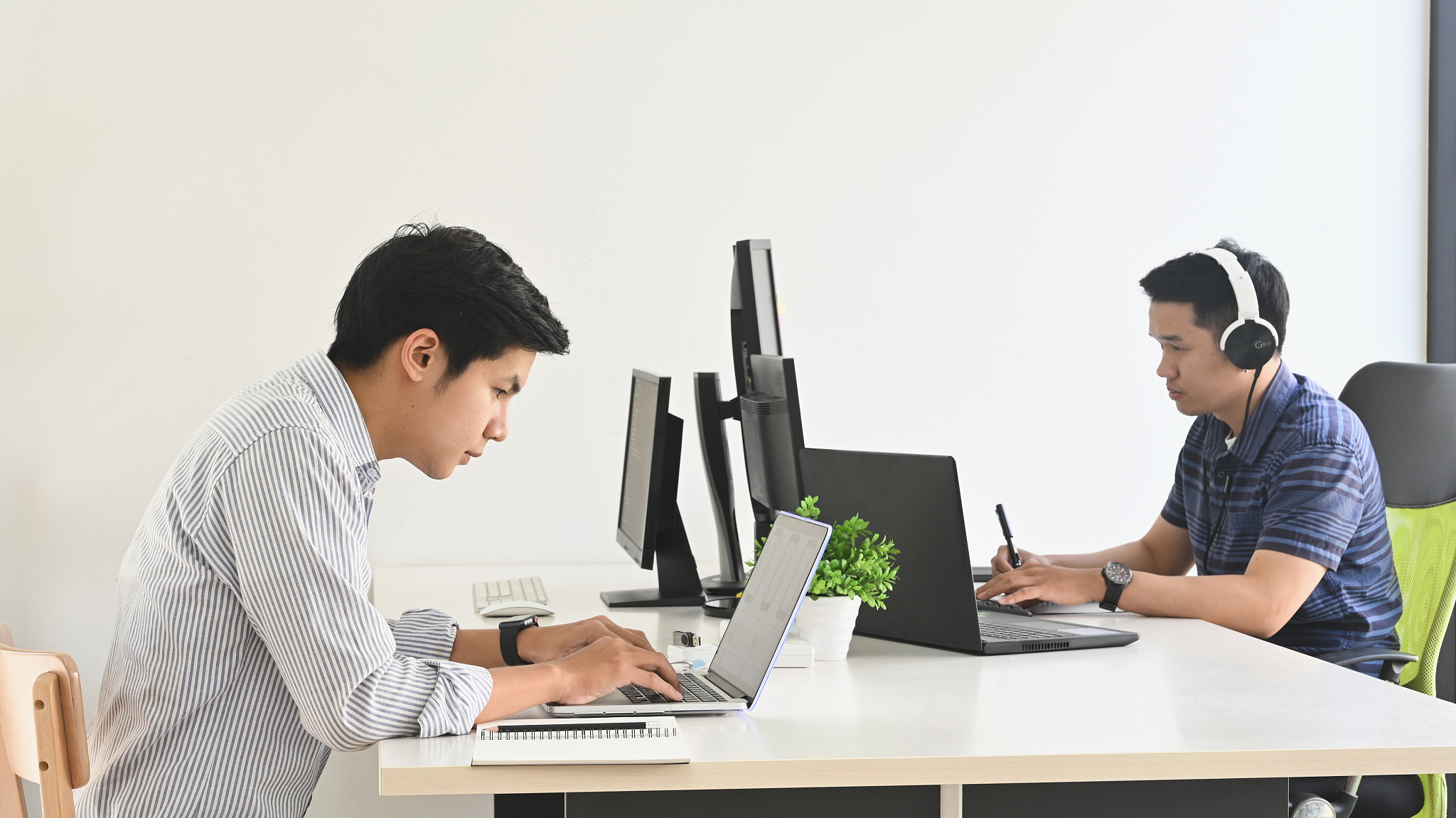 photo of young programmer team while they are working/giving a c