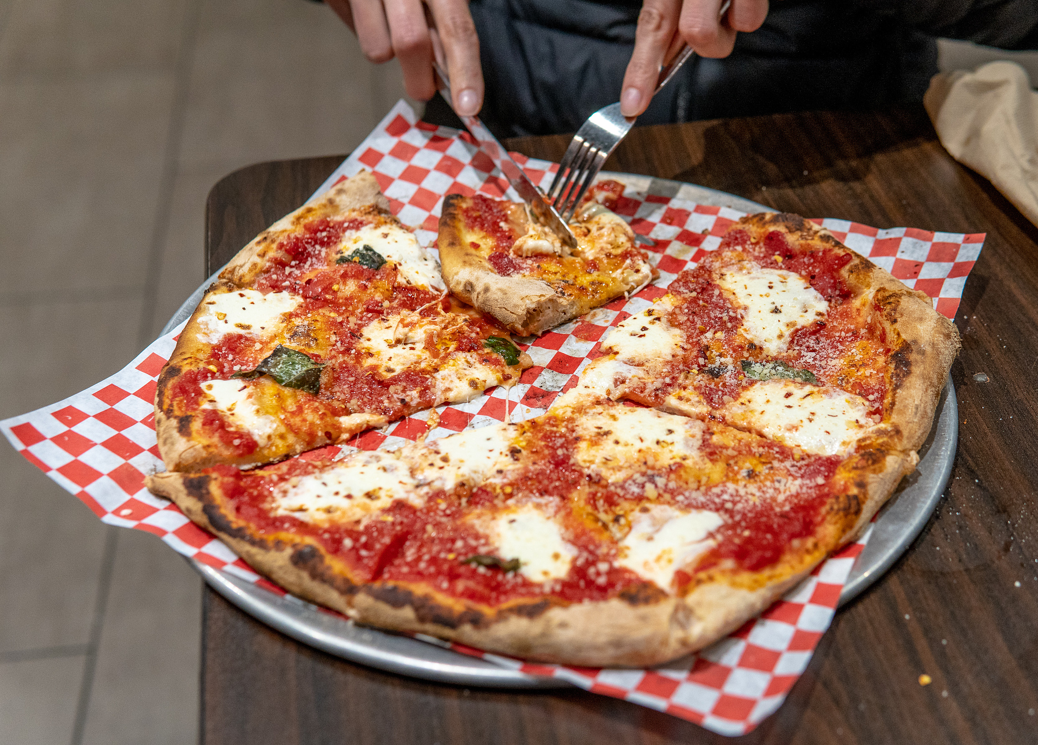 cutting slice of cheese pizza