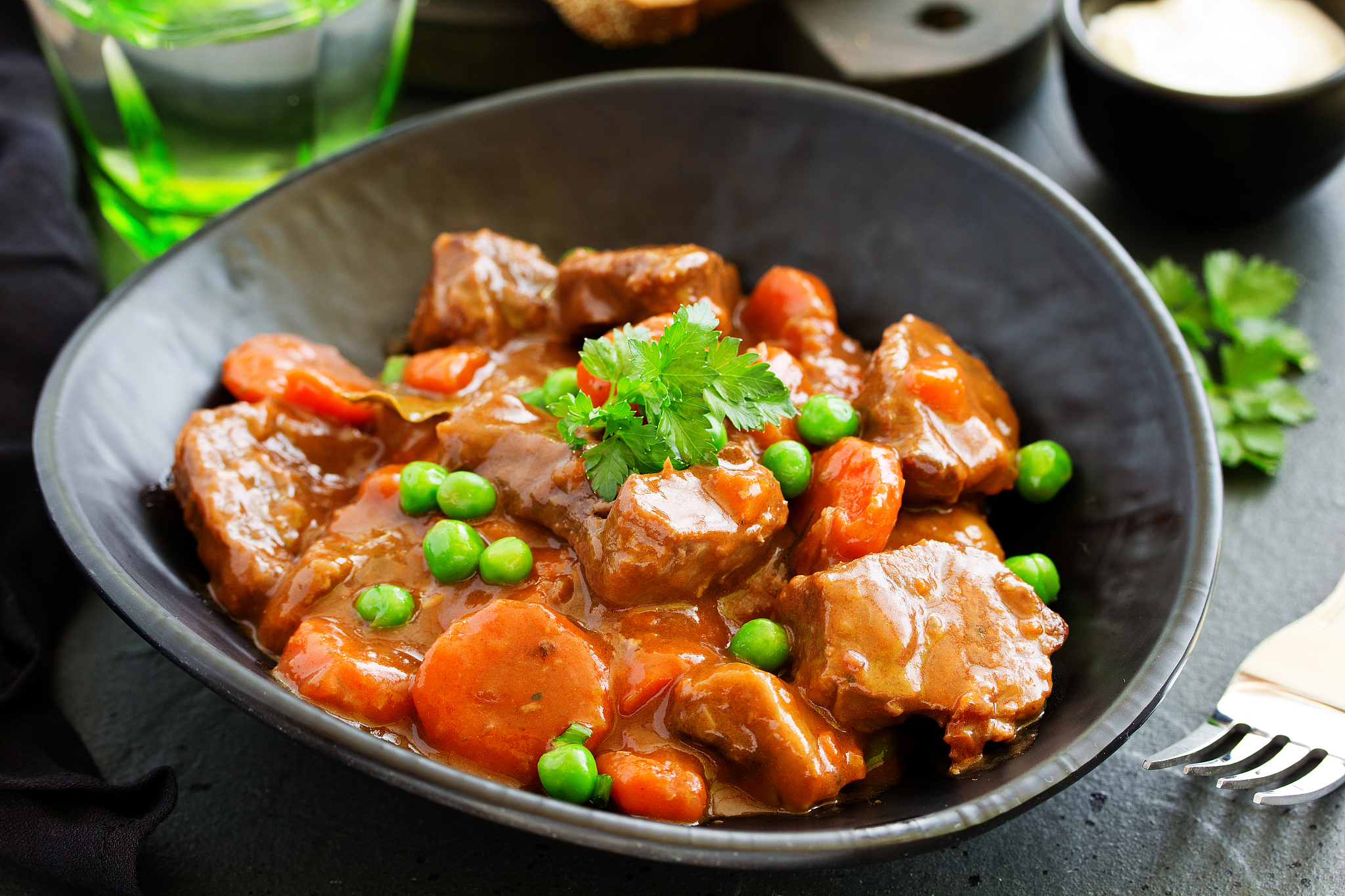 beef stew in burgundy. with carrots, onions, peas and champignon