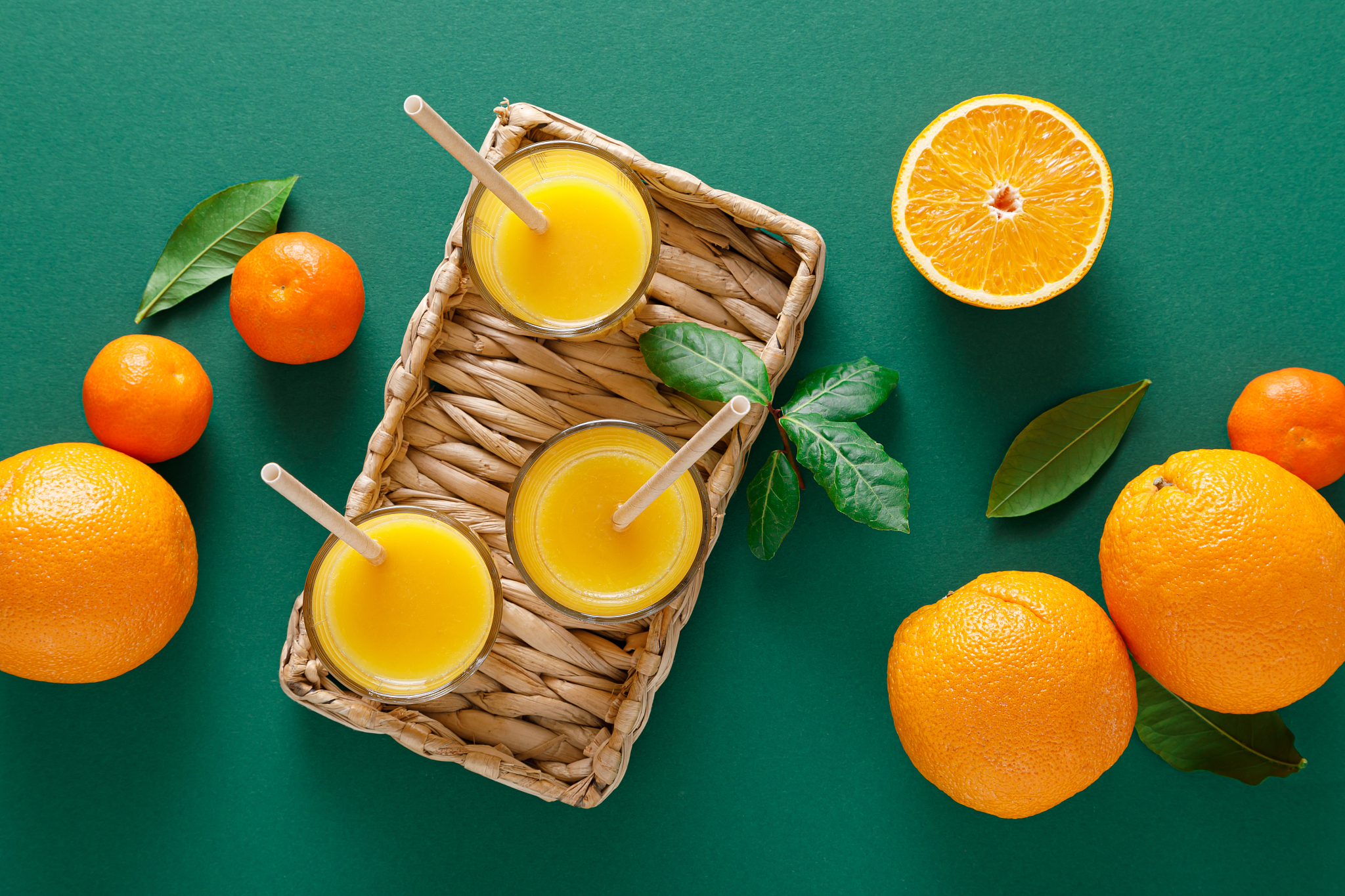 freshly squeezed orange juice in a glass pitcher and fresh fruit