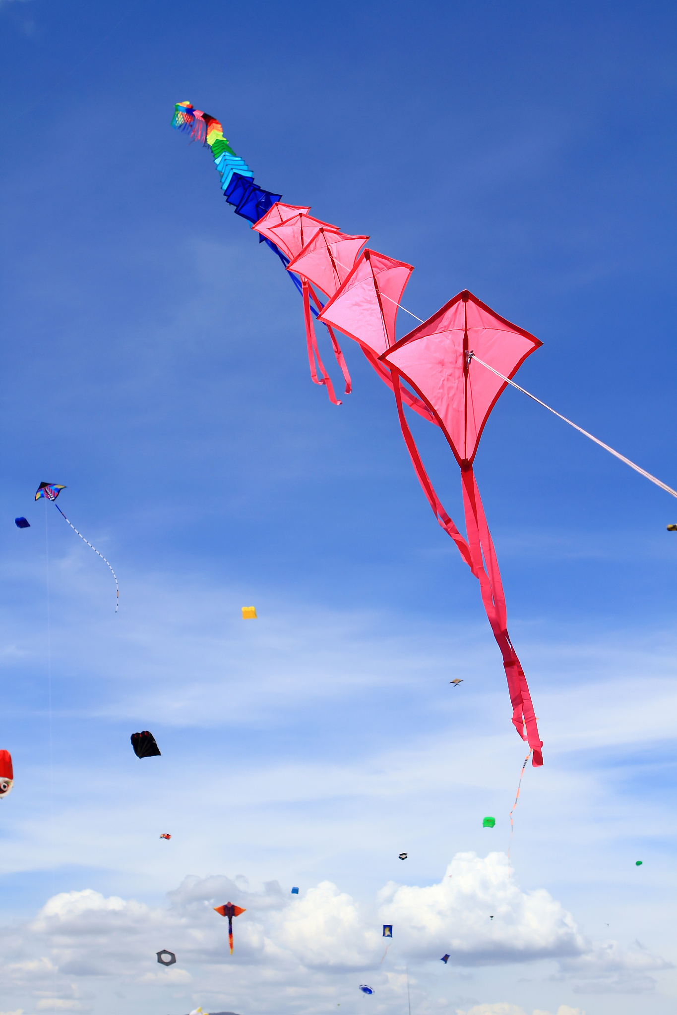 low angle view of kites flying in blue sky