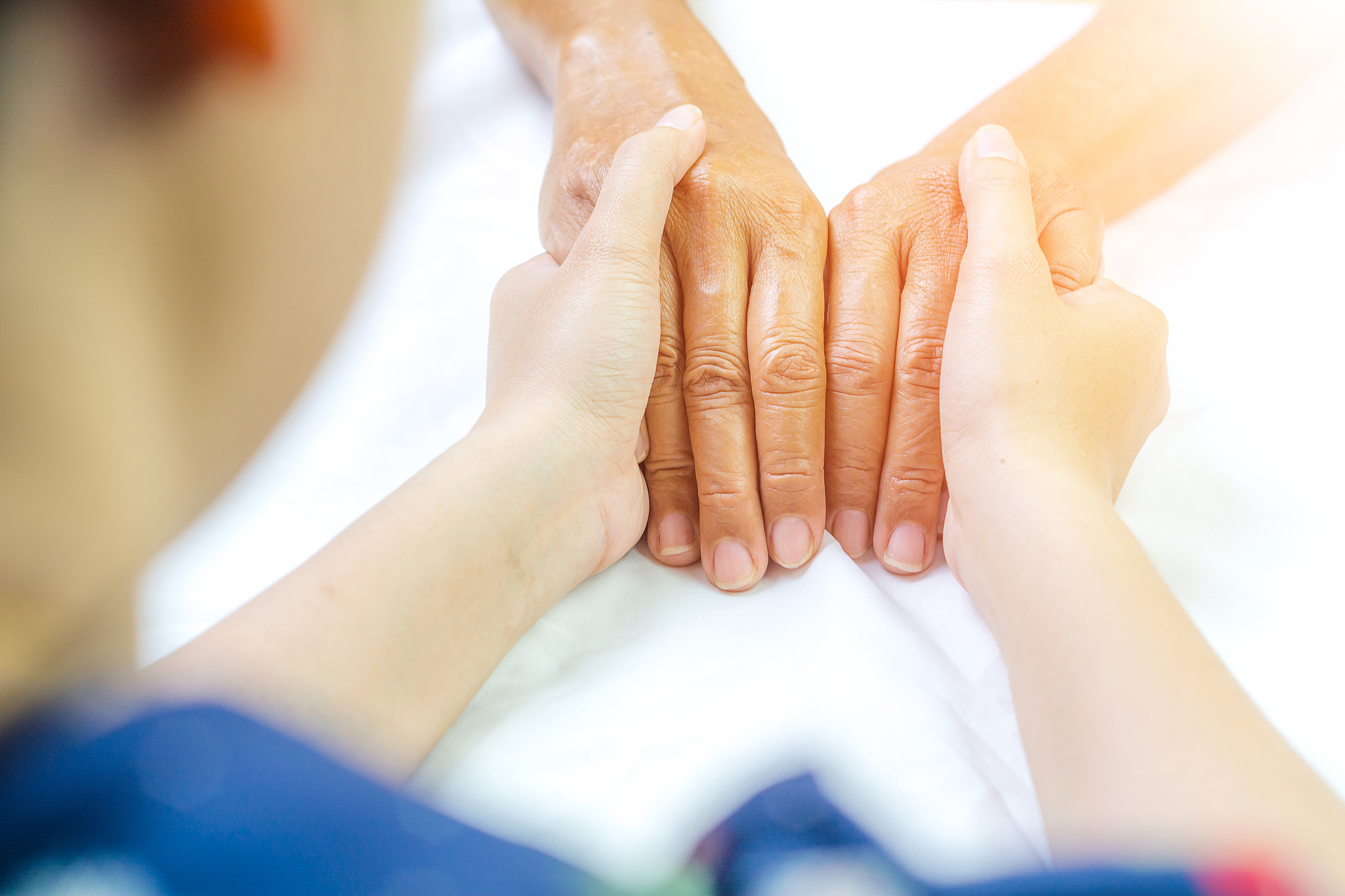 asian senior and asian young holding hands.