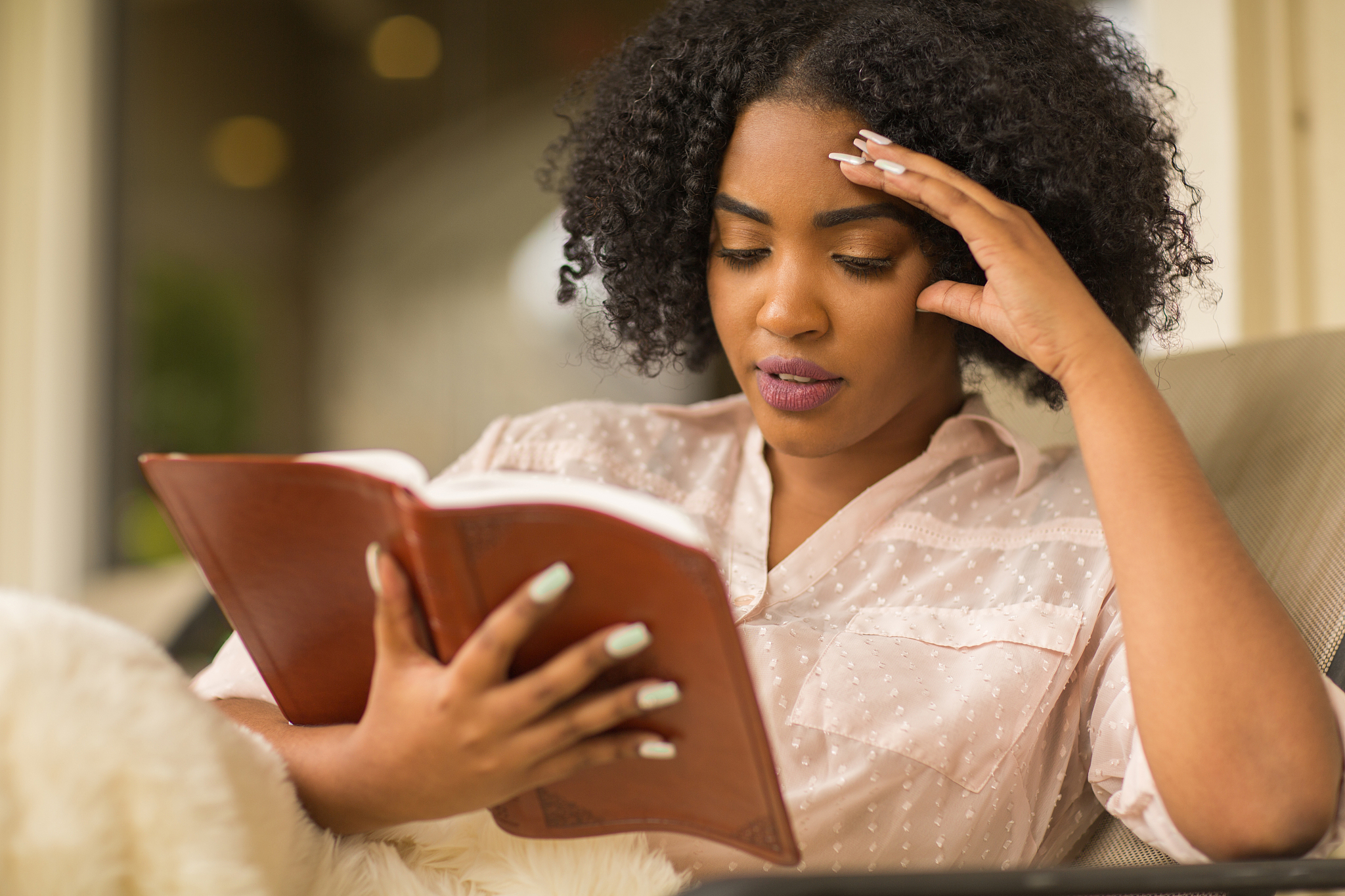african american woman reading and upset.