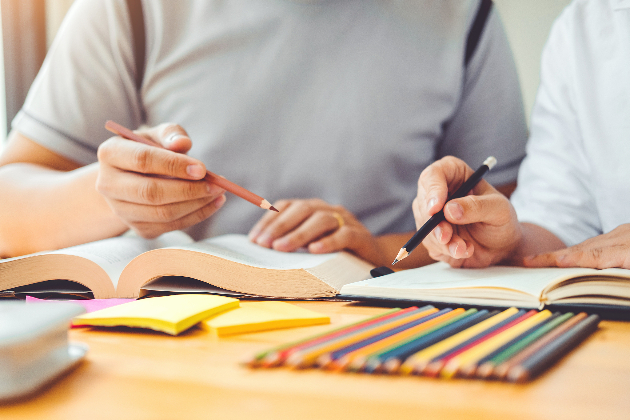 high school or college students studying and reading together in