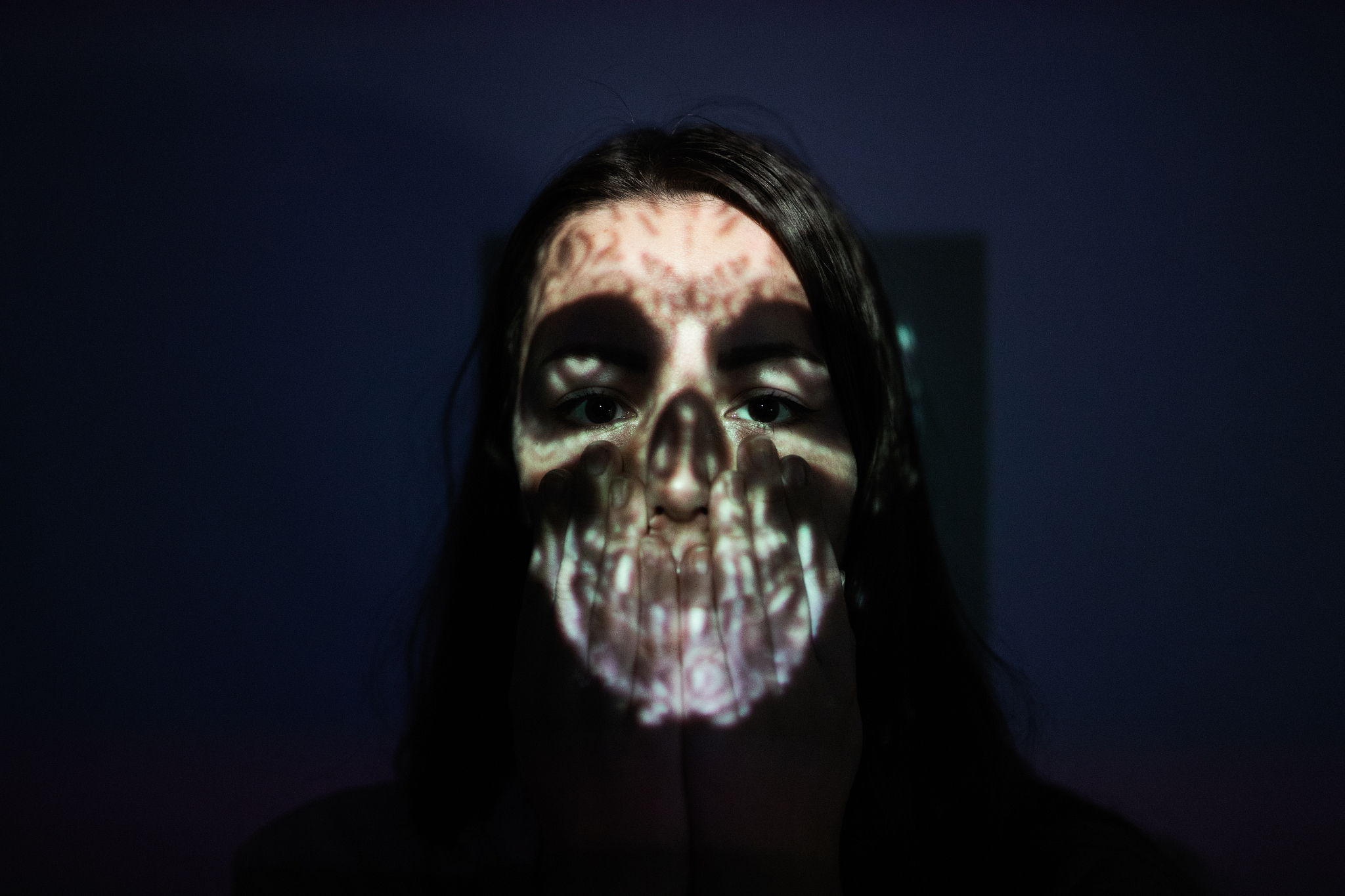 close-up of spooky woman against colored background