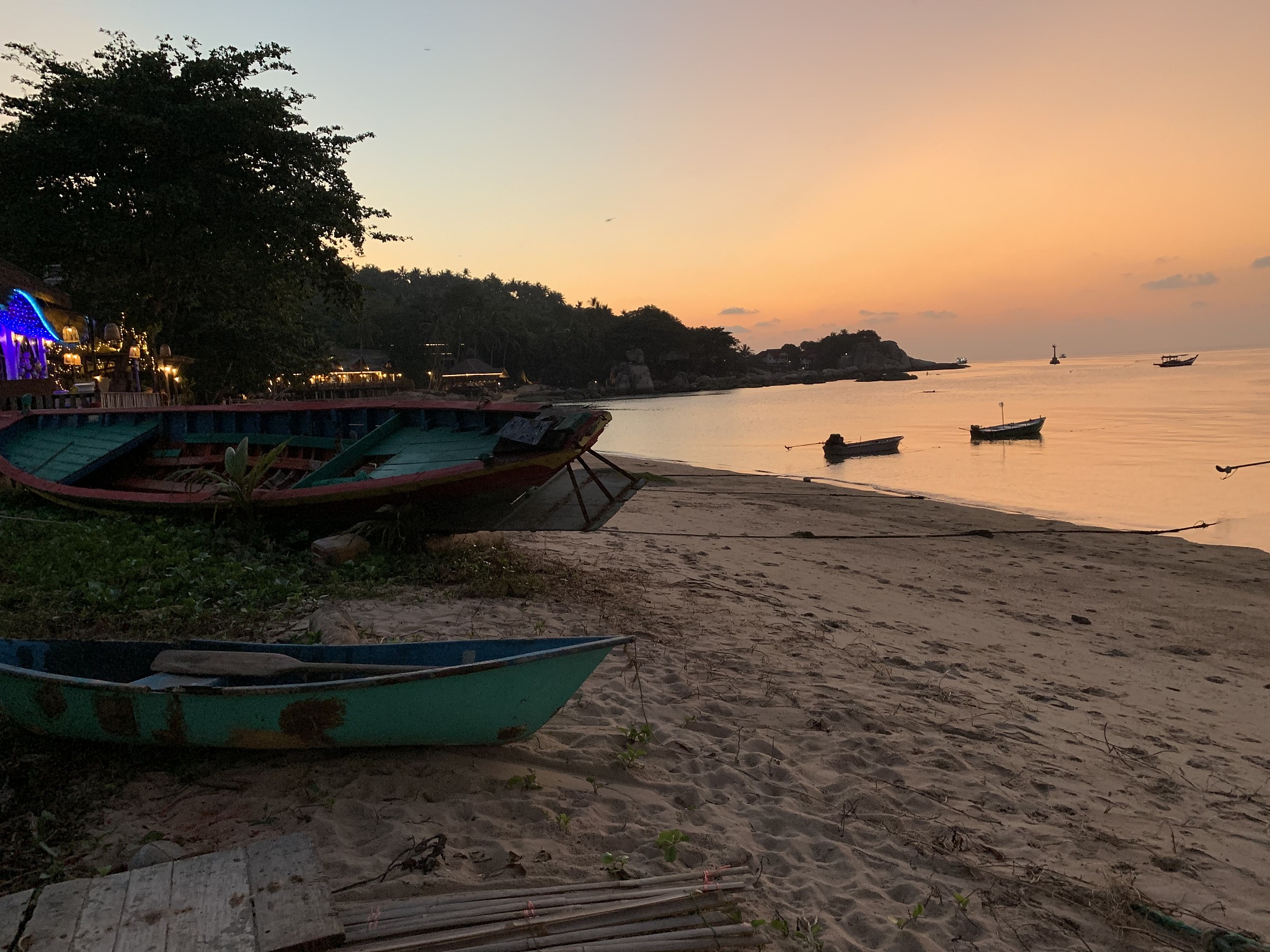landscape view of boat beach coastline at sunset