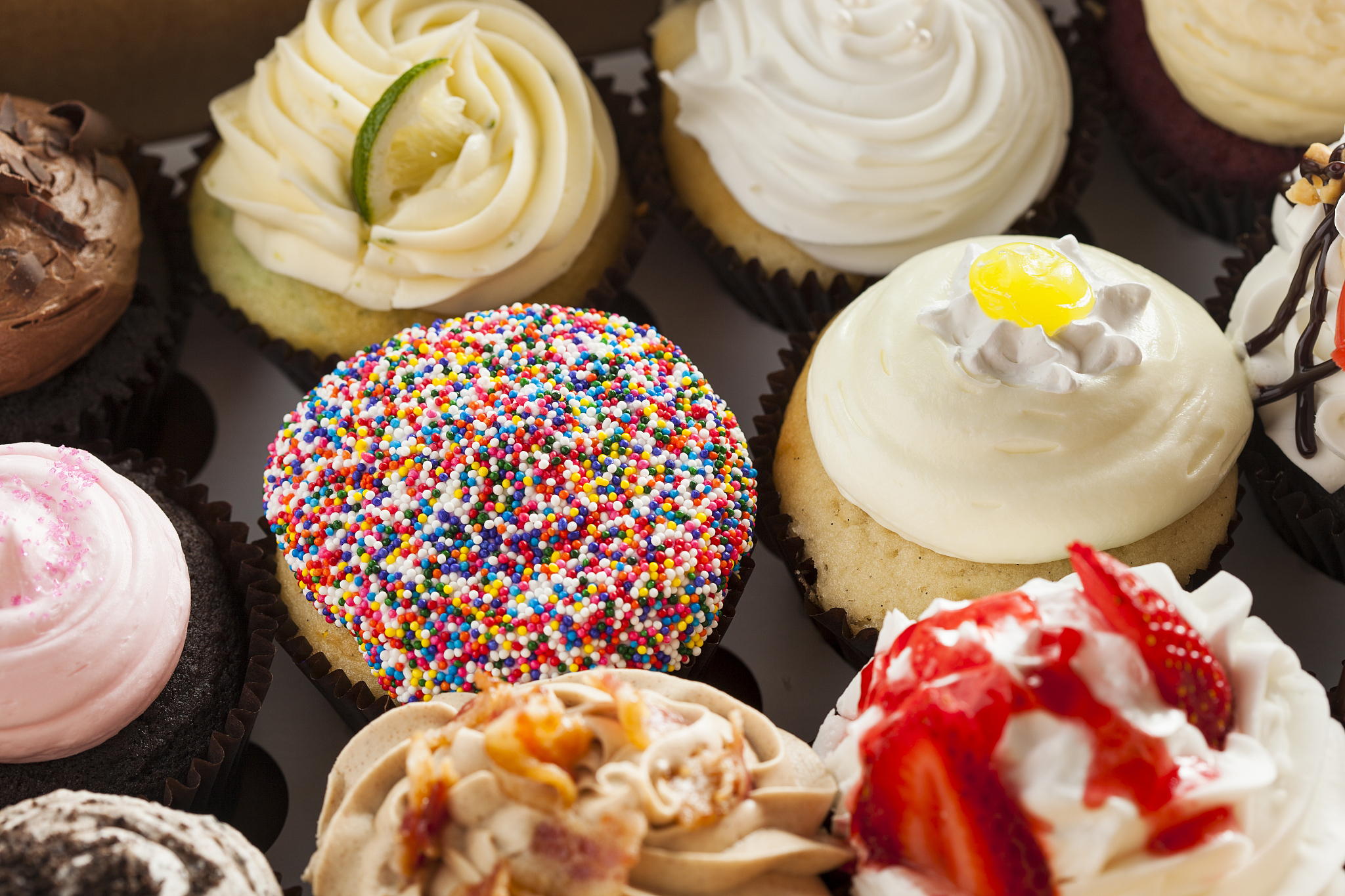 assorted fancy gourmet cupcakes with frosting