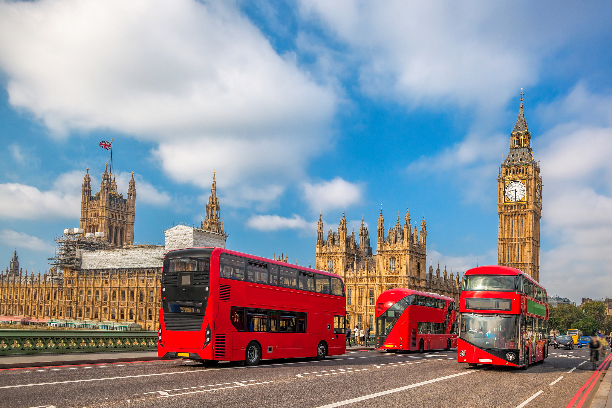 london with red buses against big ben in england, uk