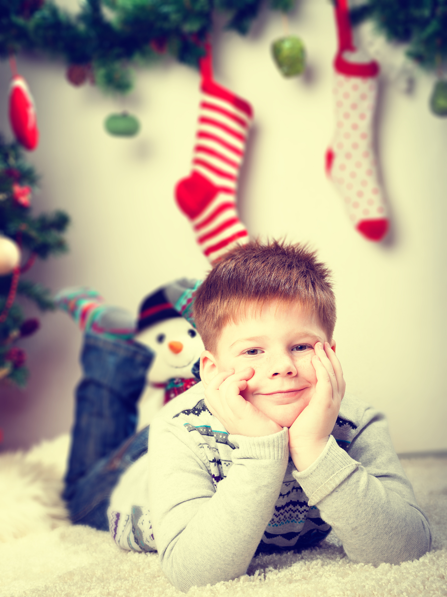 happy smiling little boy near the christmas tree