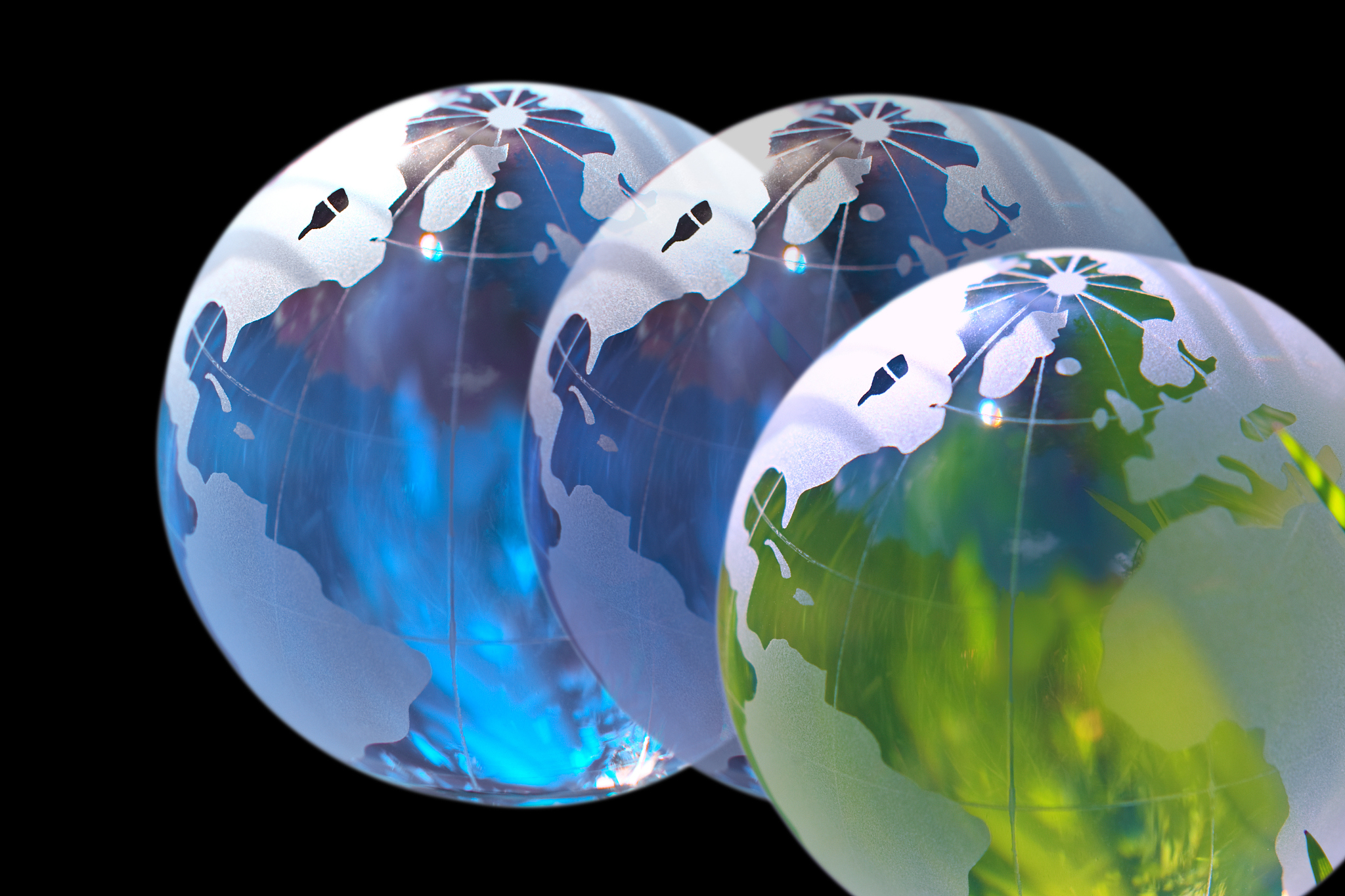 three world globes showing the americas and europe