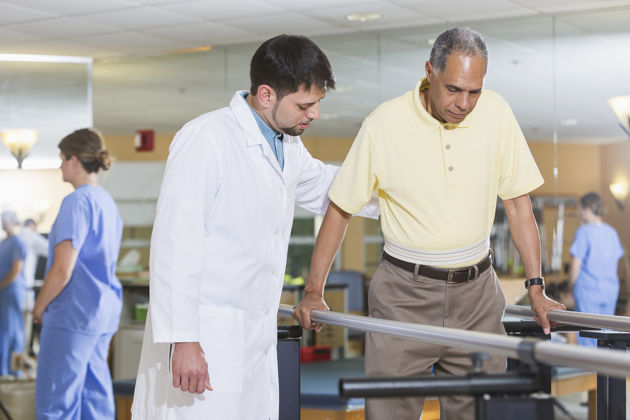 physical therapist working with male patient