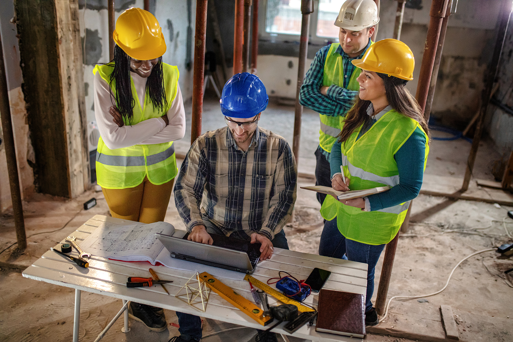 workers at construction job site inside building