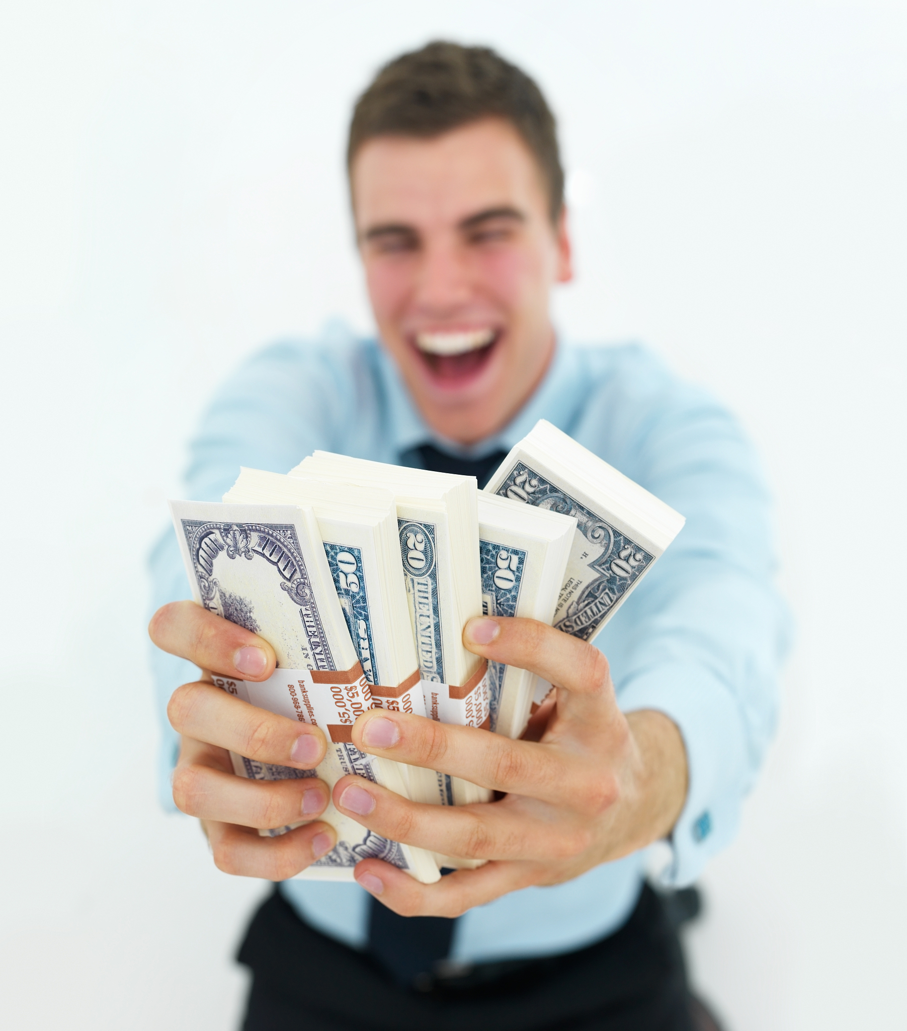 business man holding out money isolated on white background