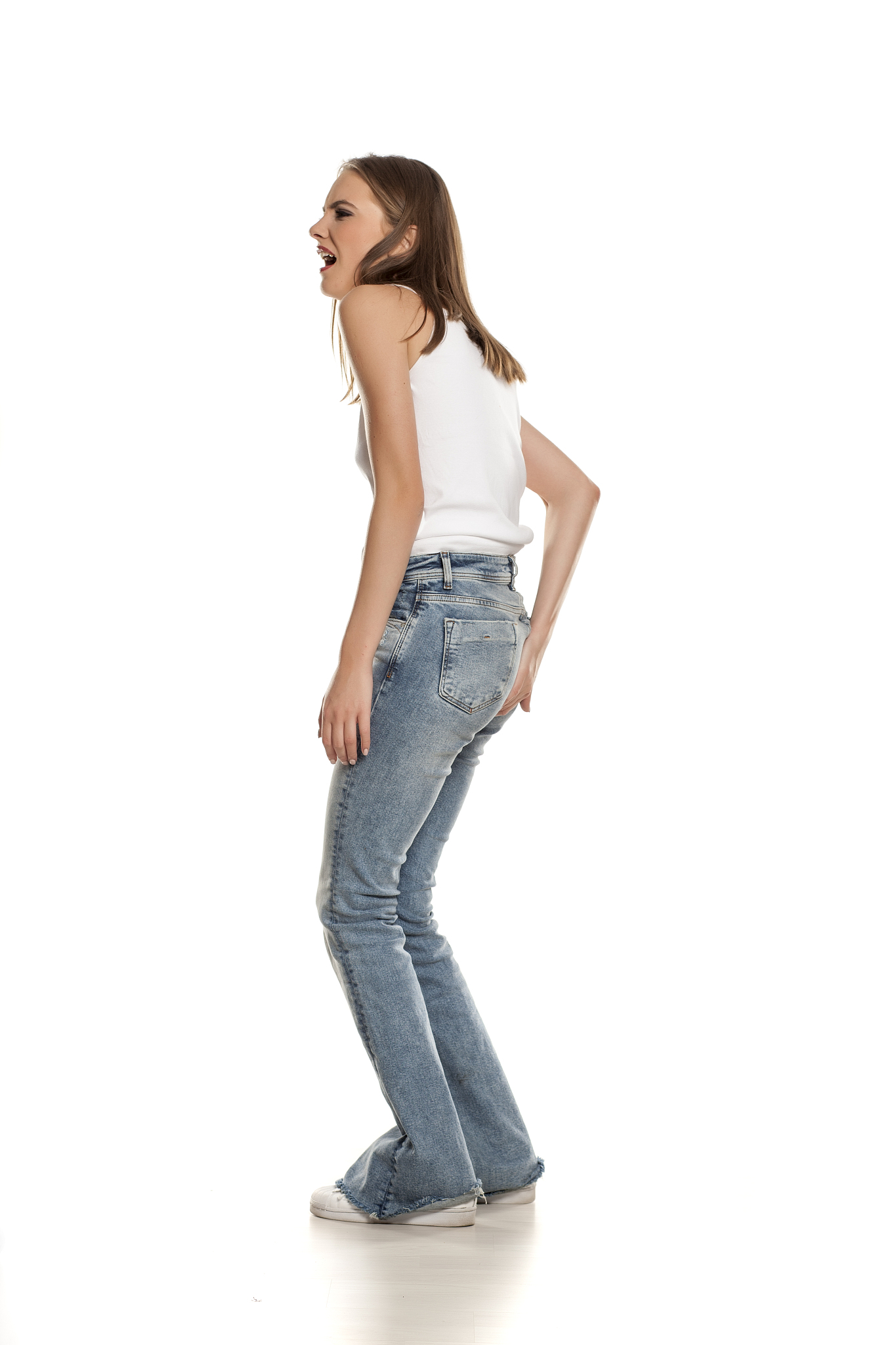 unappy young pretty woman needs a toilet on white background
