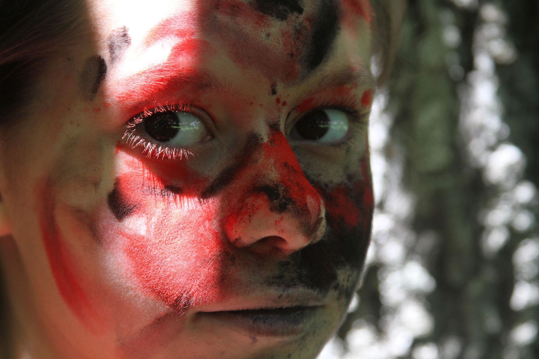 young girl splattered with red and black paint