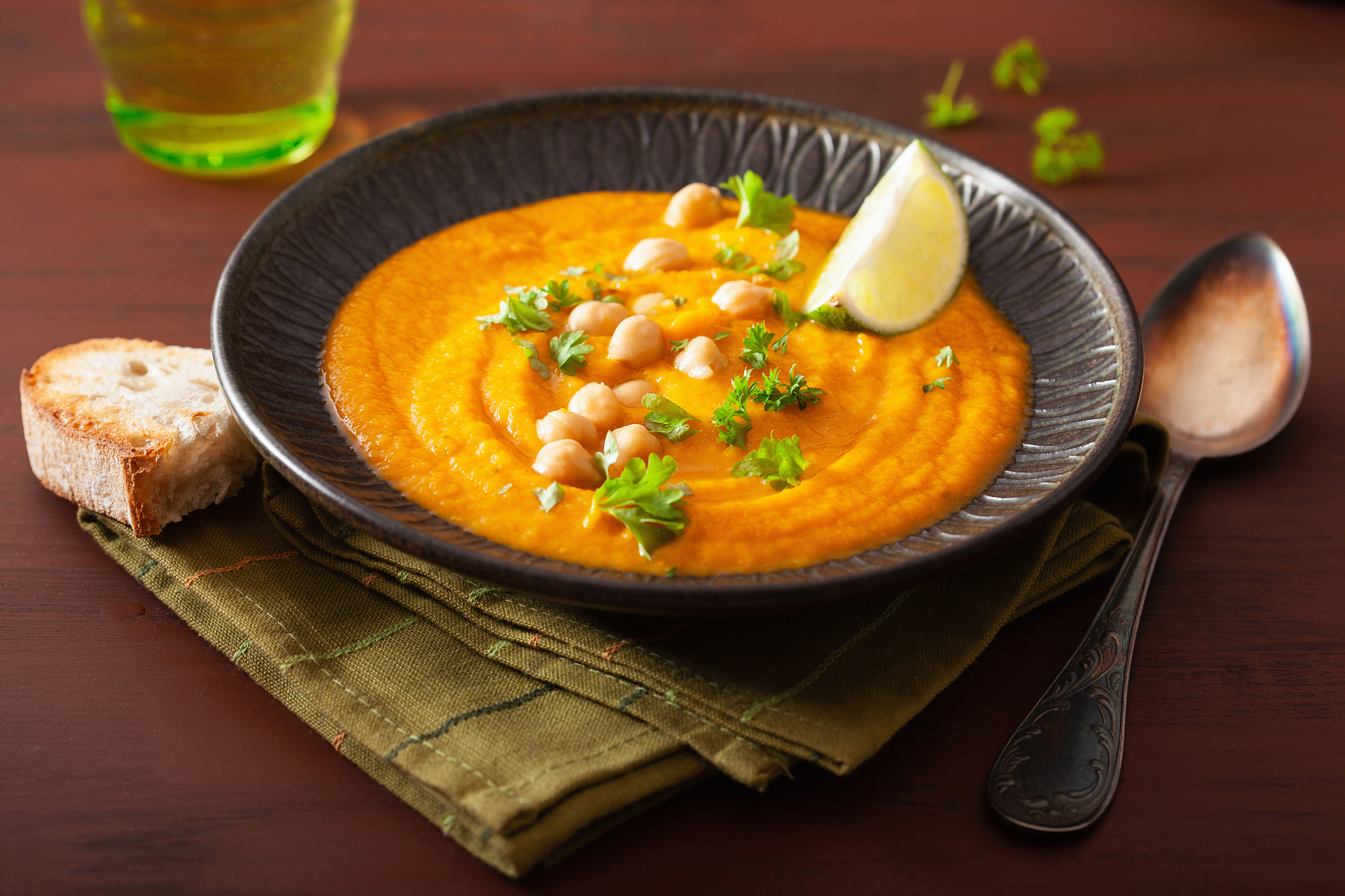 creamy carrot chickpea soup on dark rustic background