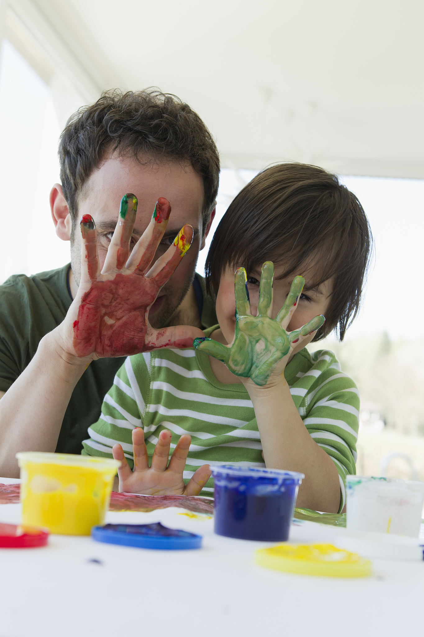 father and son finger painting together