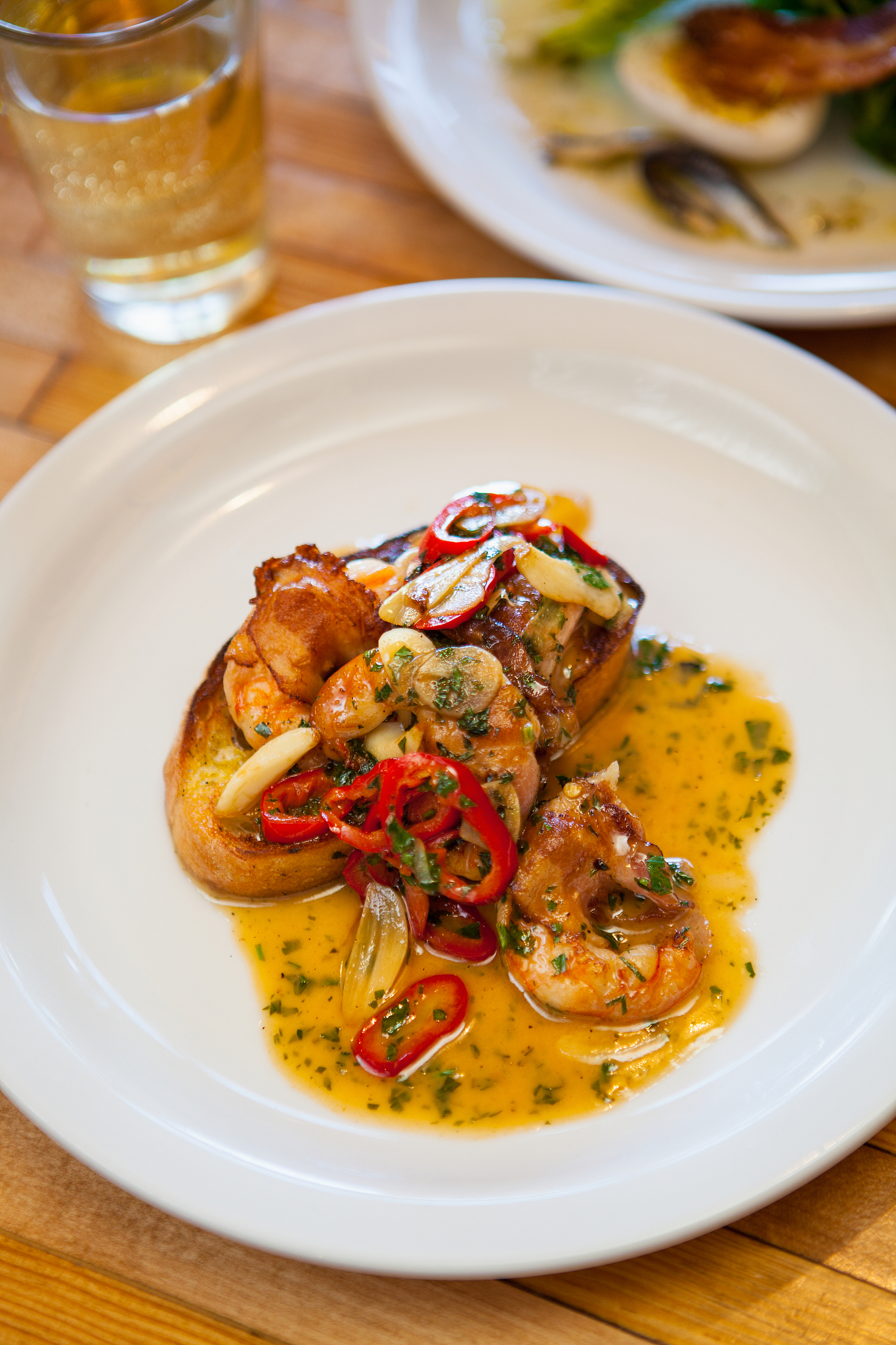 pancetta-wrapped white shrimp with a glass of chardonnay
