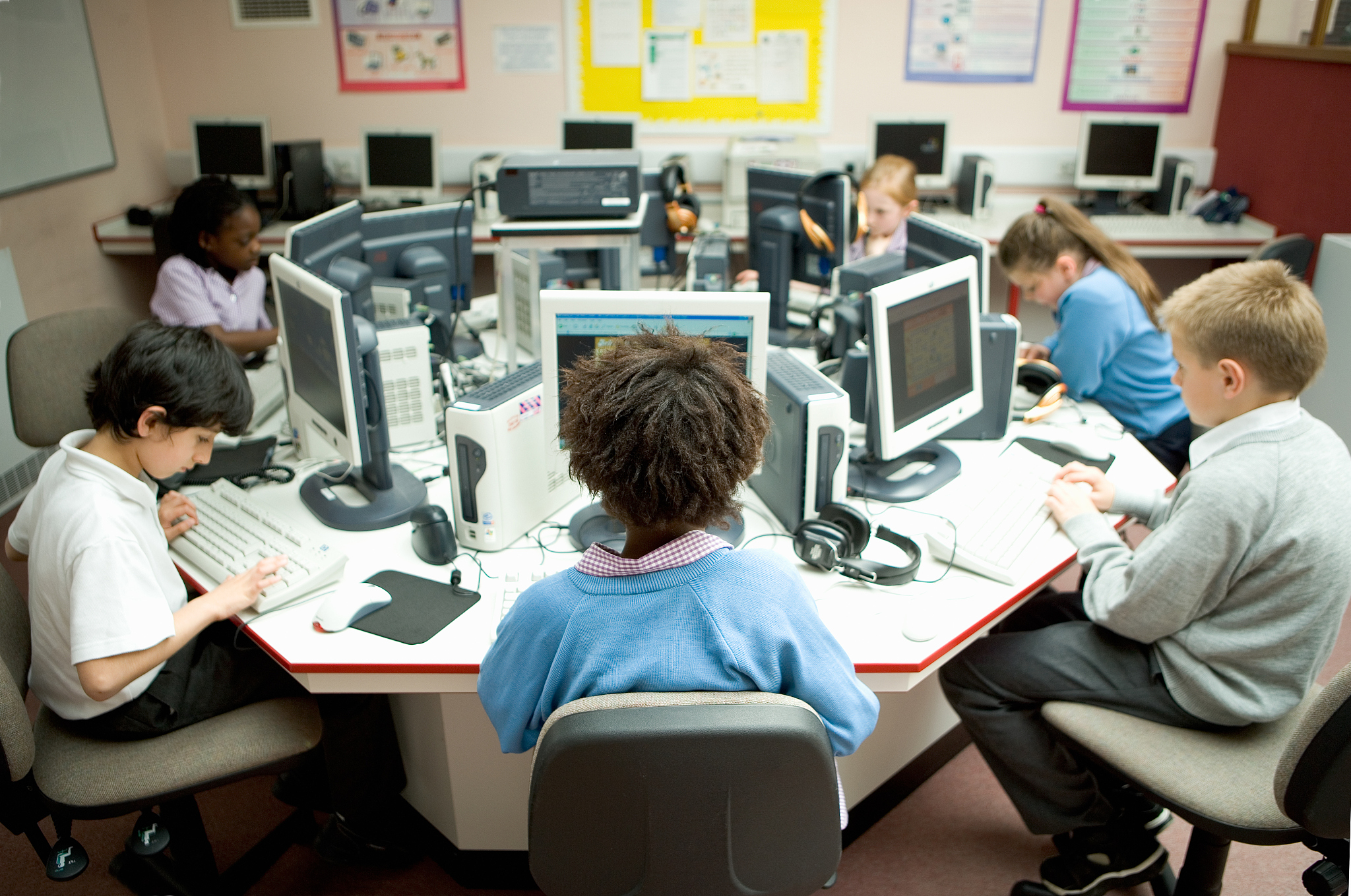children (7-12) studying with computers in computer laboratory