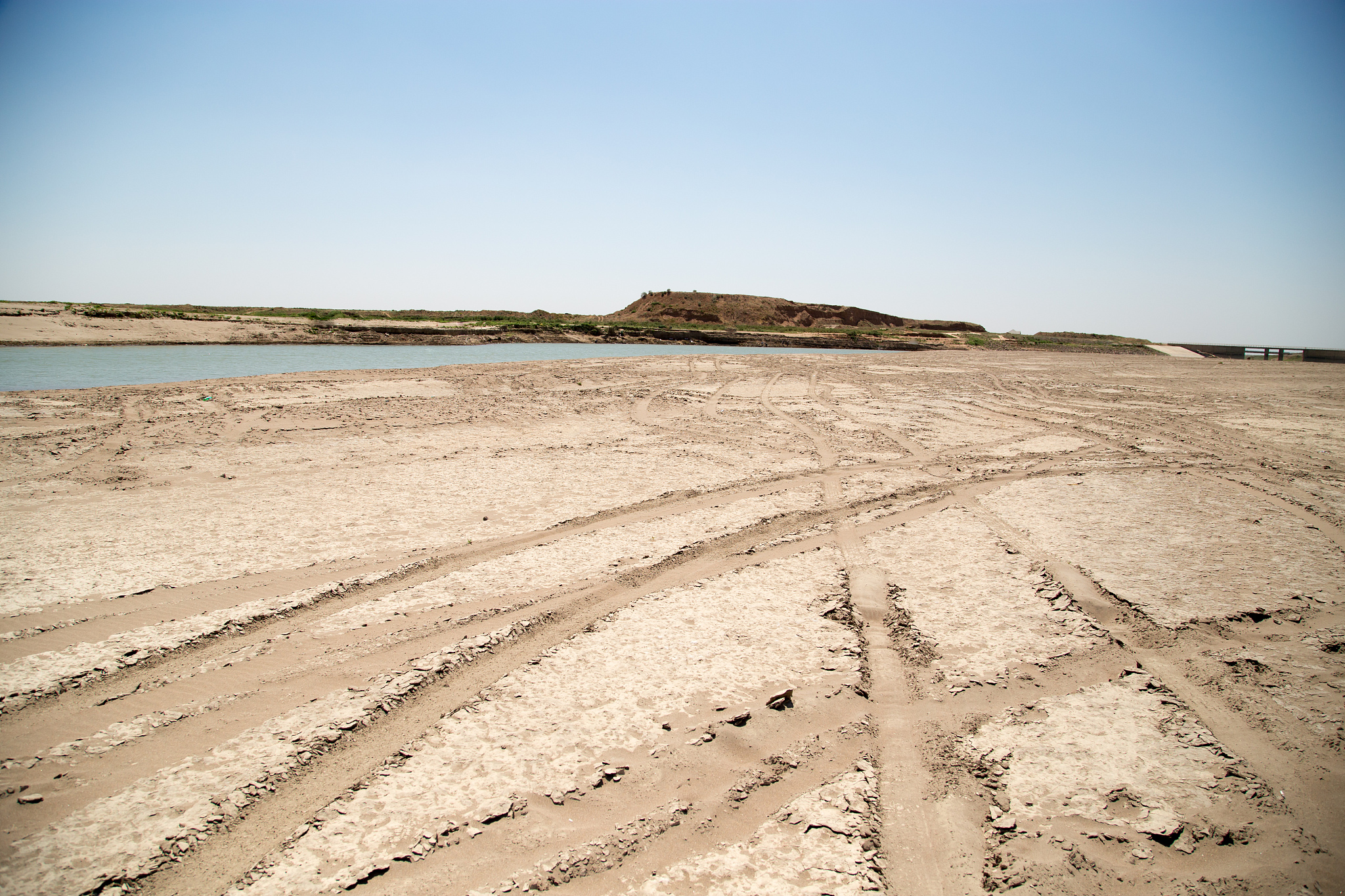 car track on the sand in the desert
