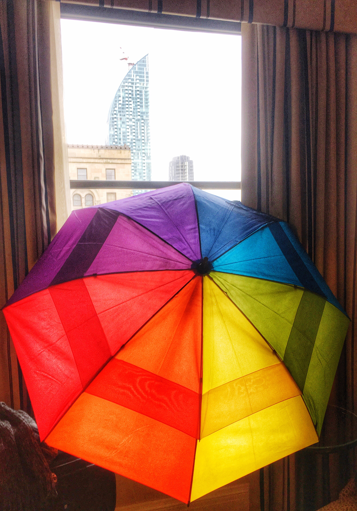 colorful umbrella by glass window at home