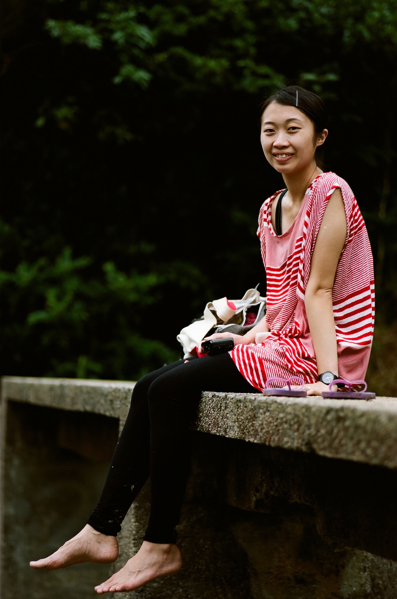 asian girl sitting on bridge
