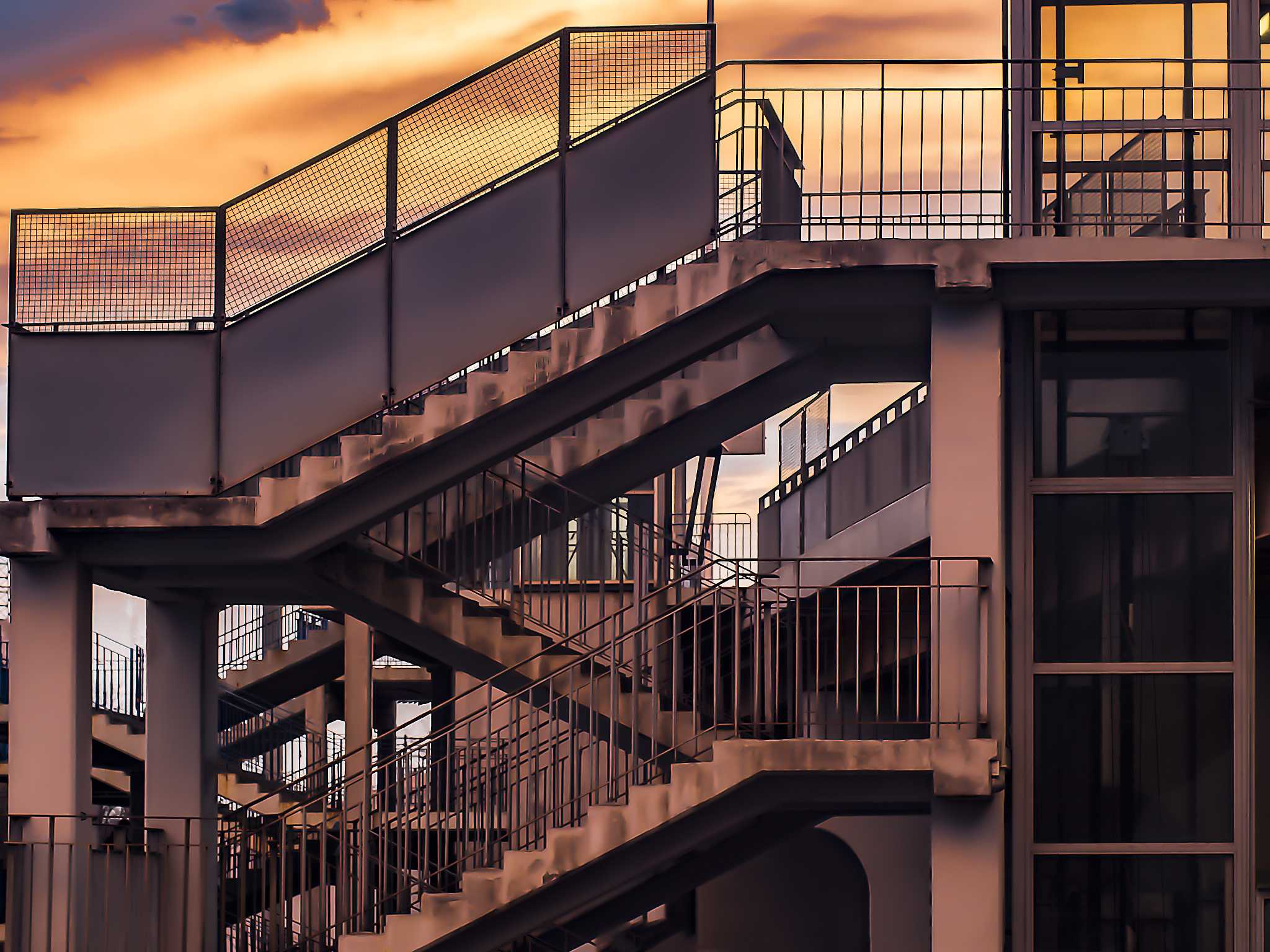 a metal concrete staircase against the background of the setting