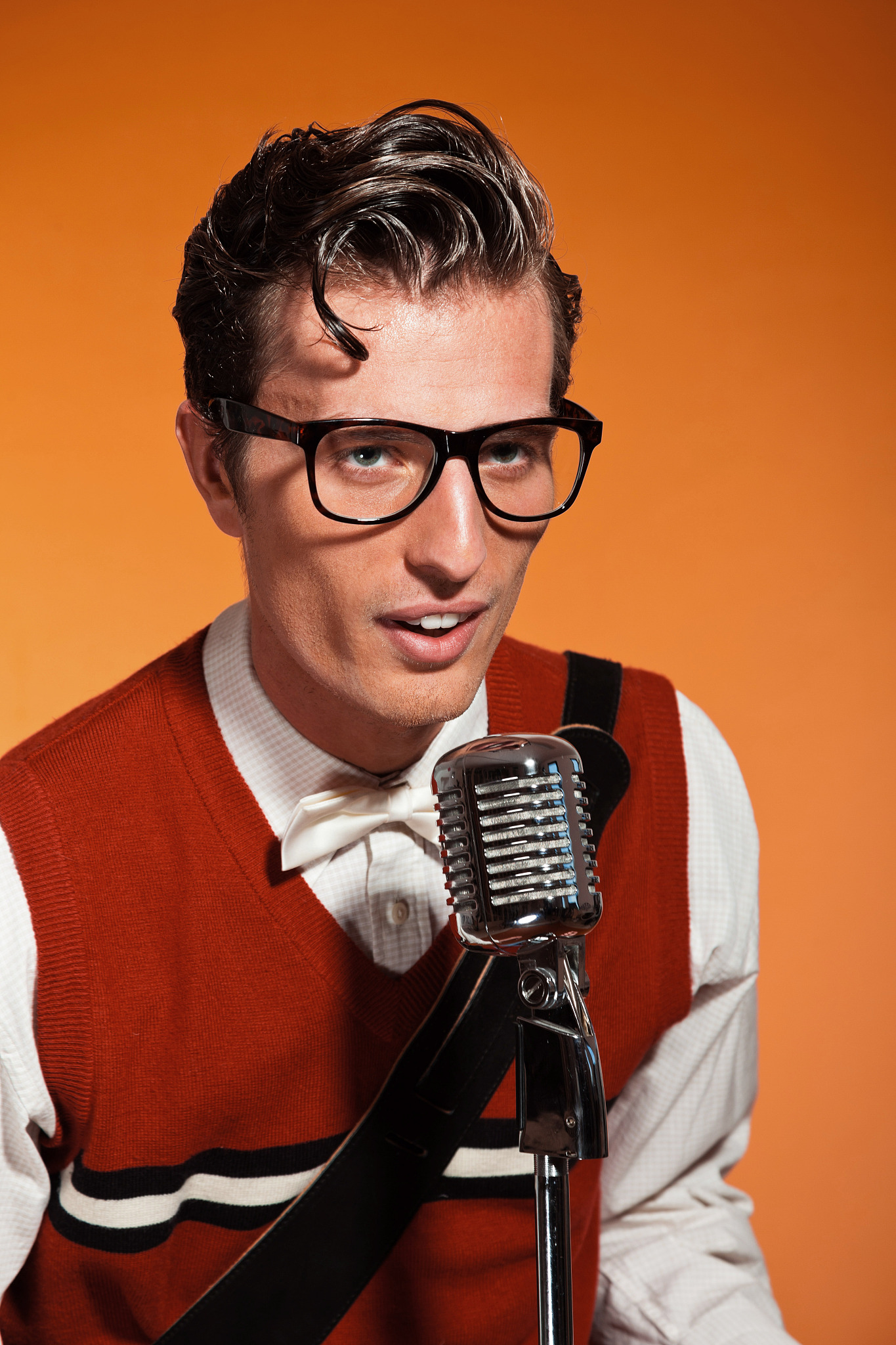 retro fifties style rock and roll singer with vintage microphone