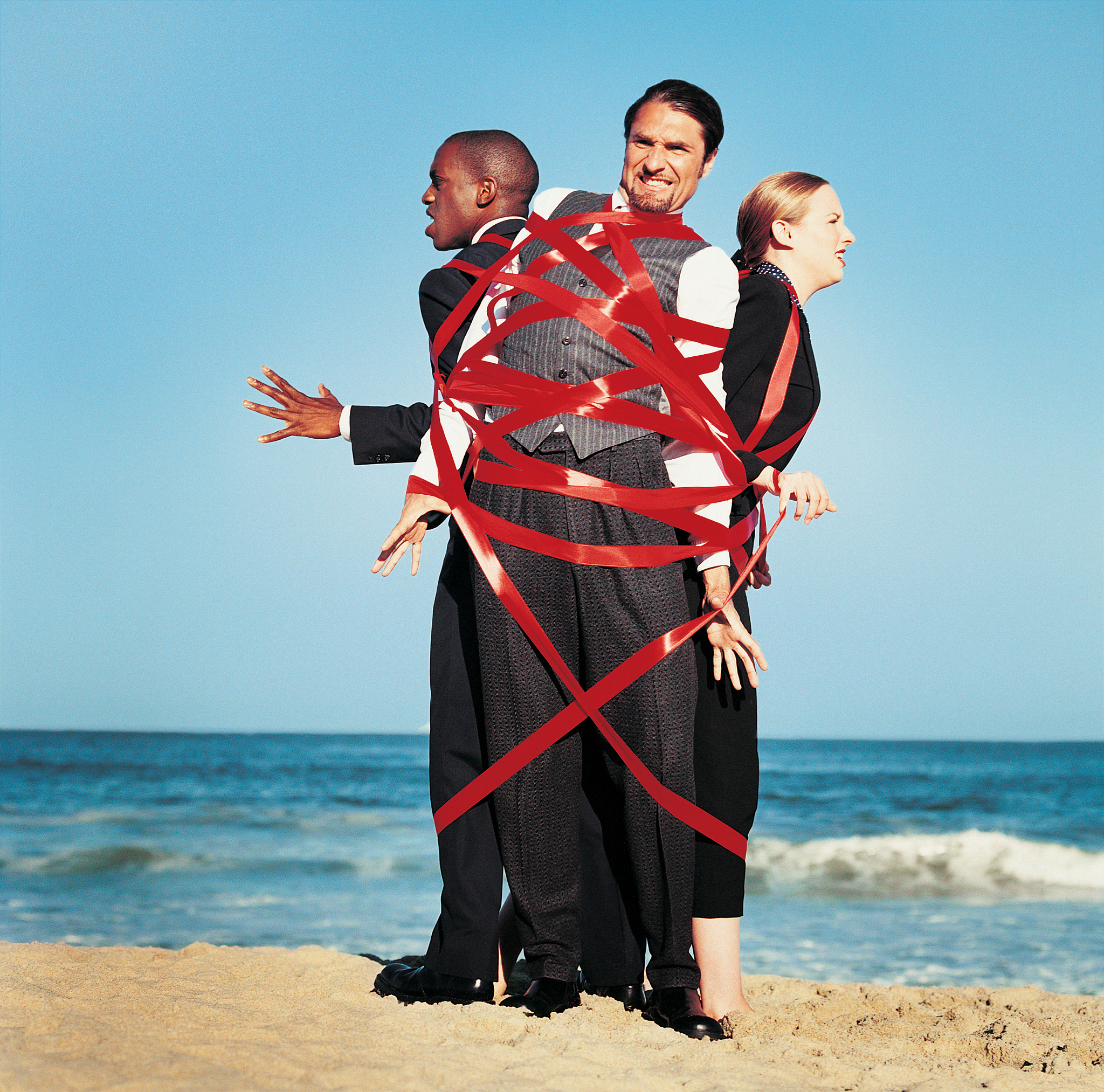 businesspeople tied up in red tape