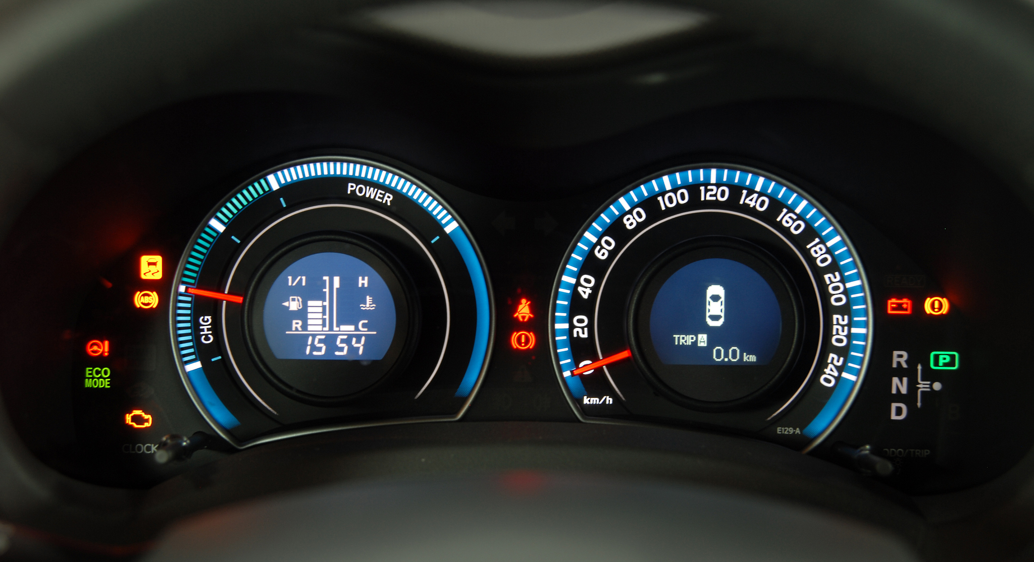 lights and icons on dashboard of hybrid car