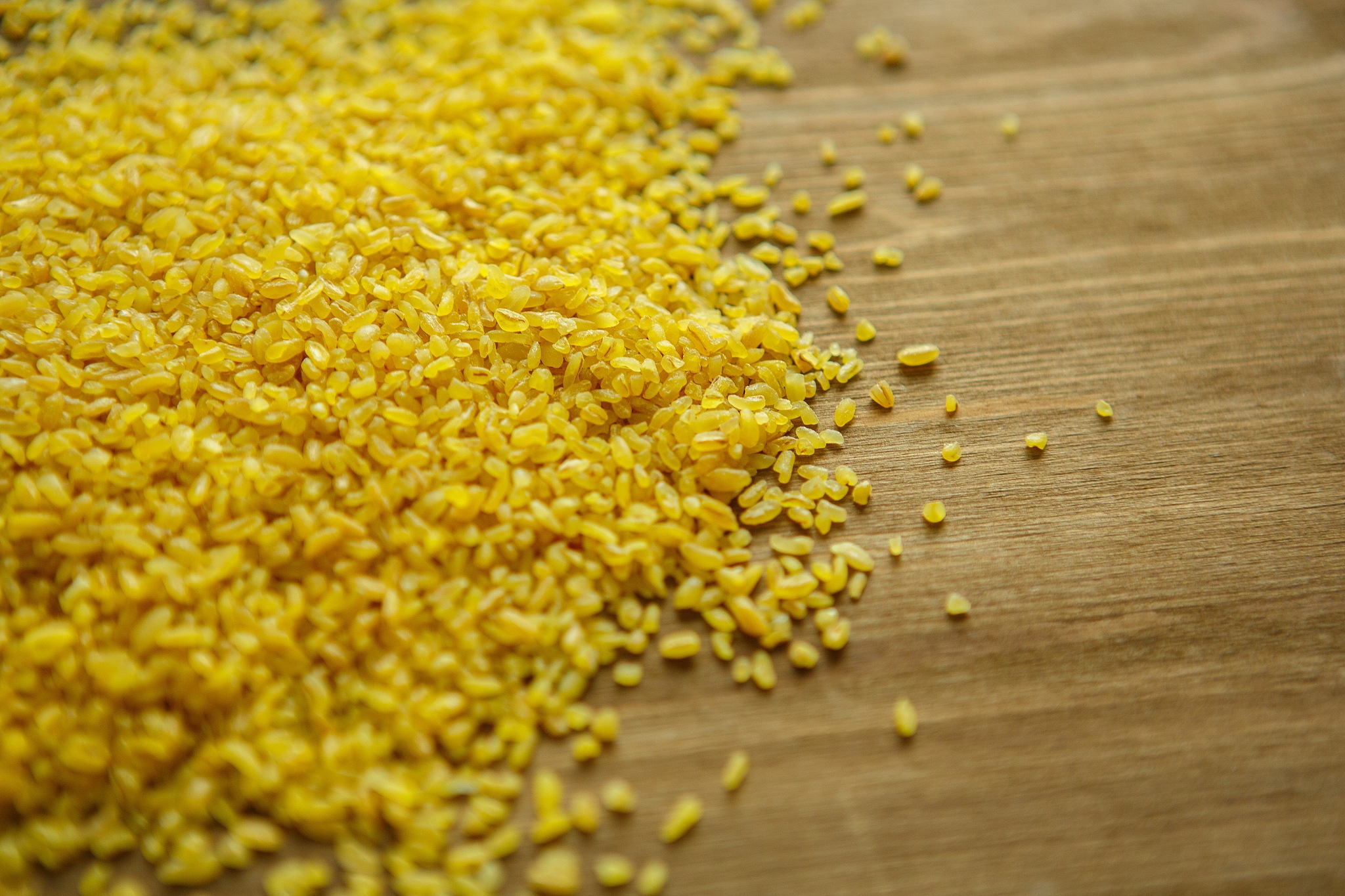 bulgur, cereals on a wooden background