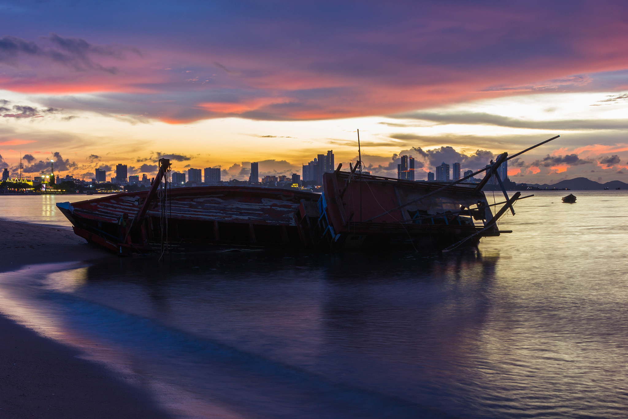 boats moored in sea against sky during sunset